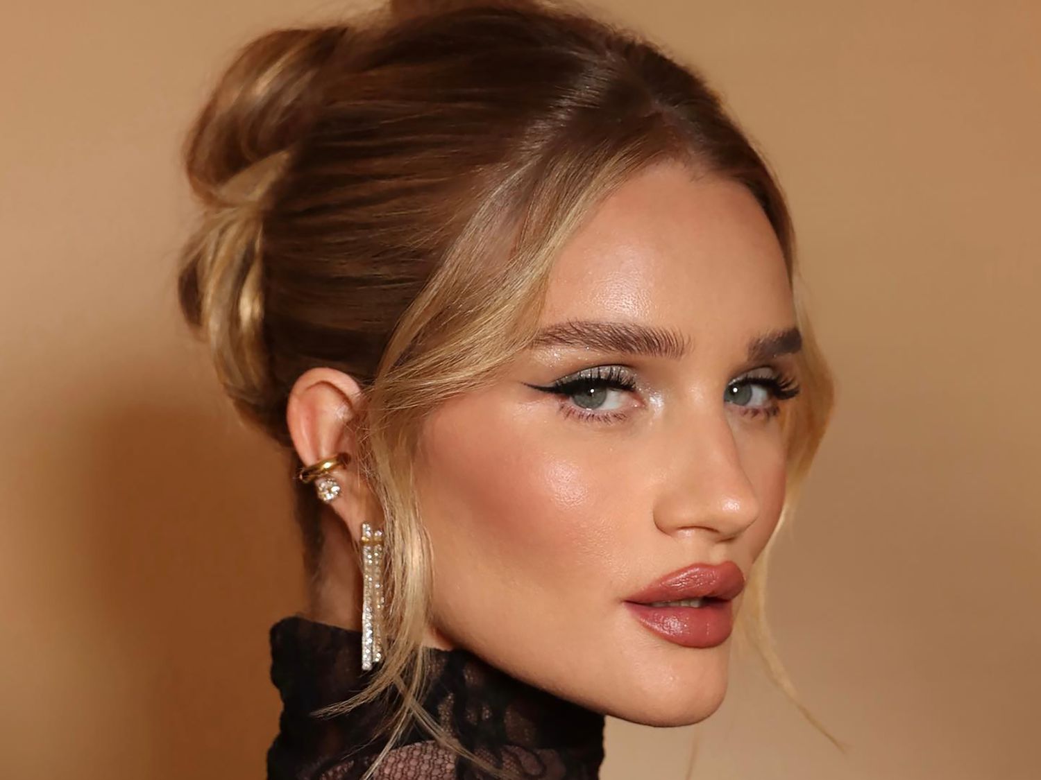 Rosie Huntington-Whitely in profile, head turned to the camera, with black winged eyeliner