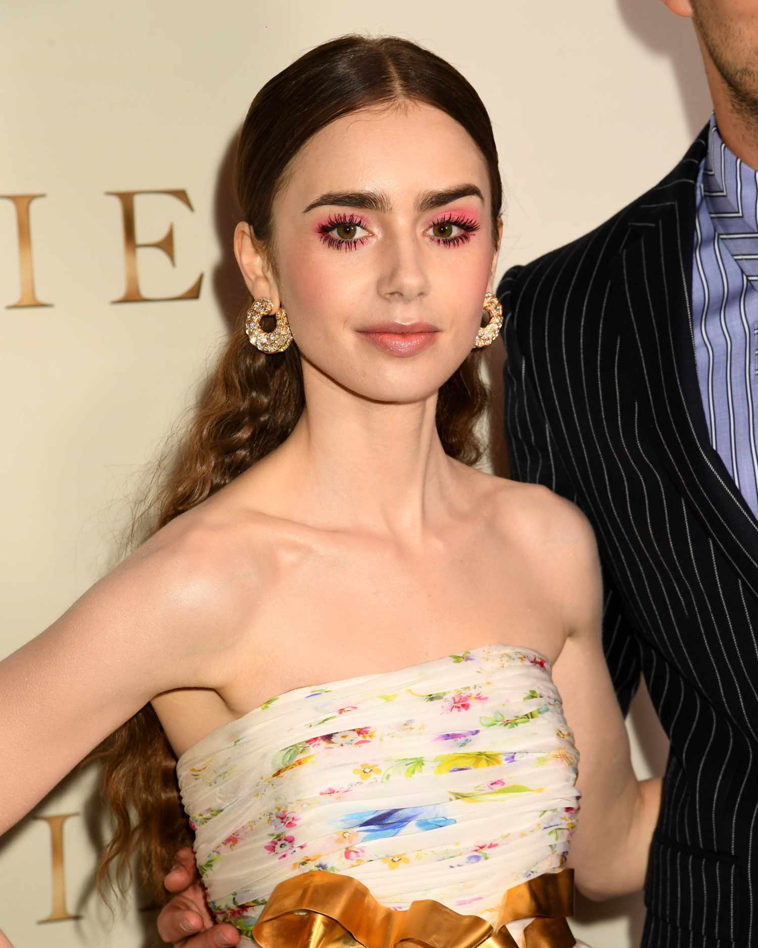 Lily Collins with a fluorescent pink halo eye makeup look