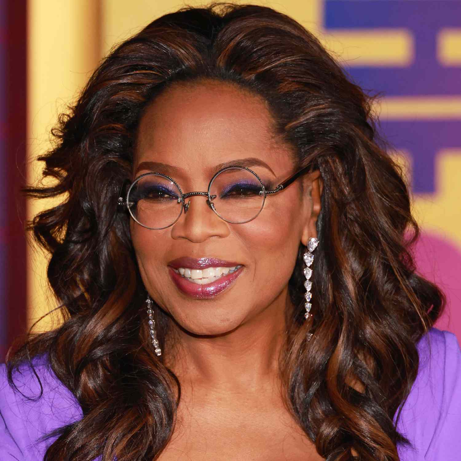 Oprah with a curly chocolate-caramel hairstyle