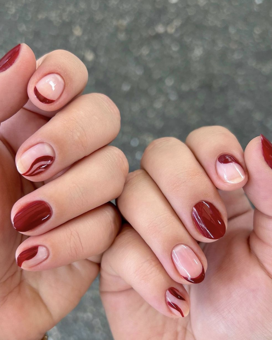 red christmas nails on a black background, good housekeeping's pick for christmas nail art