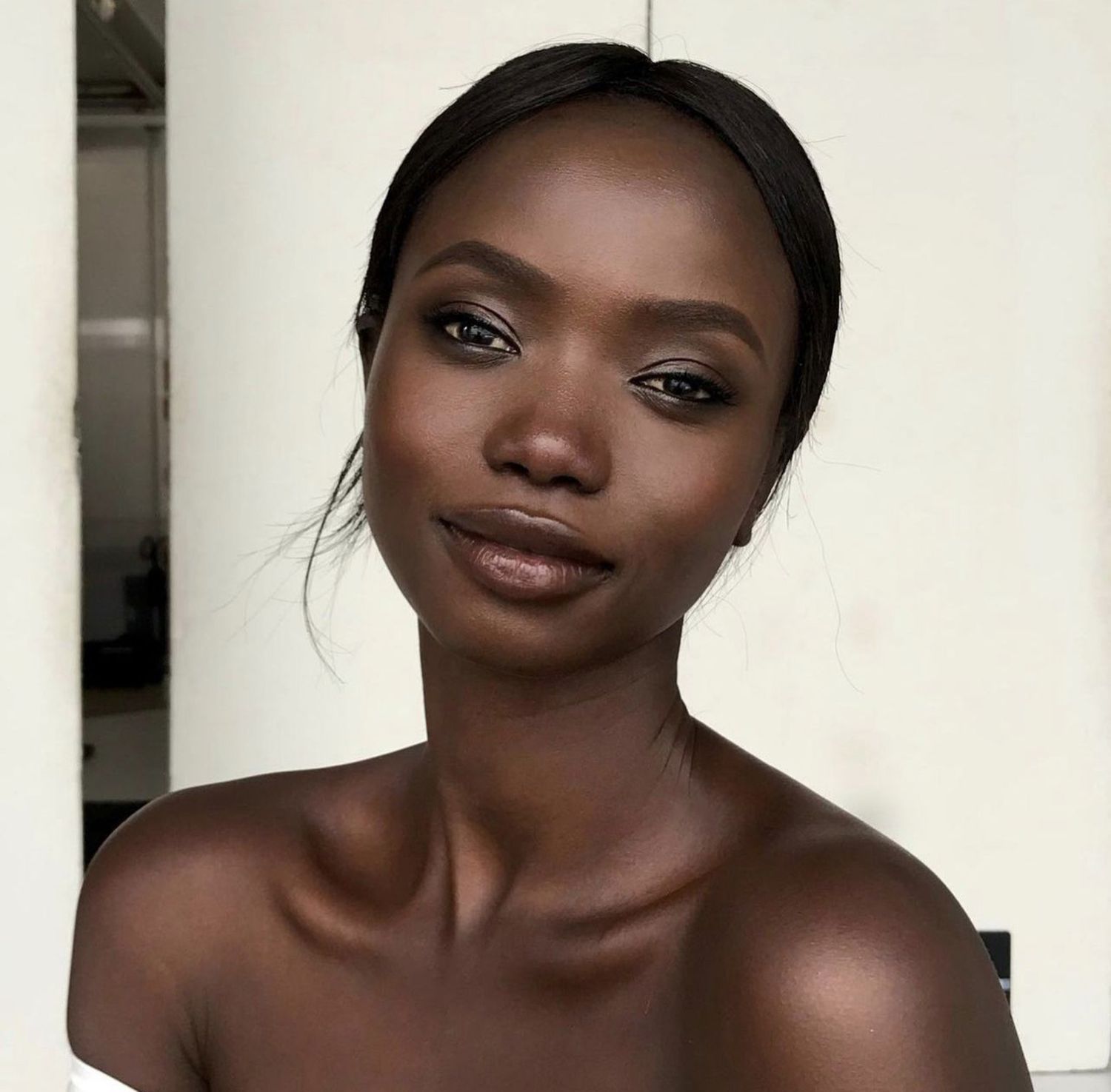 woman wearing a black smoky eye with chocolate lipstick 