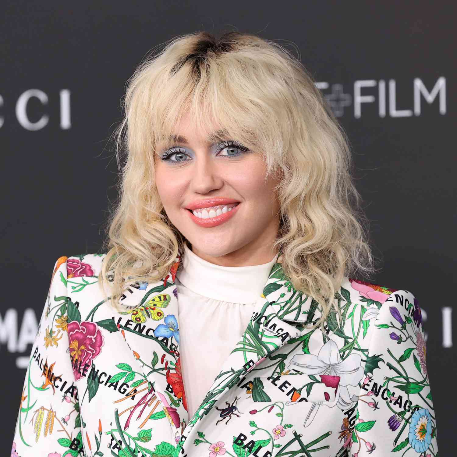 Miley Cyrus wears a wavy hairstyle with shaggy face-framing bangs