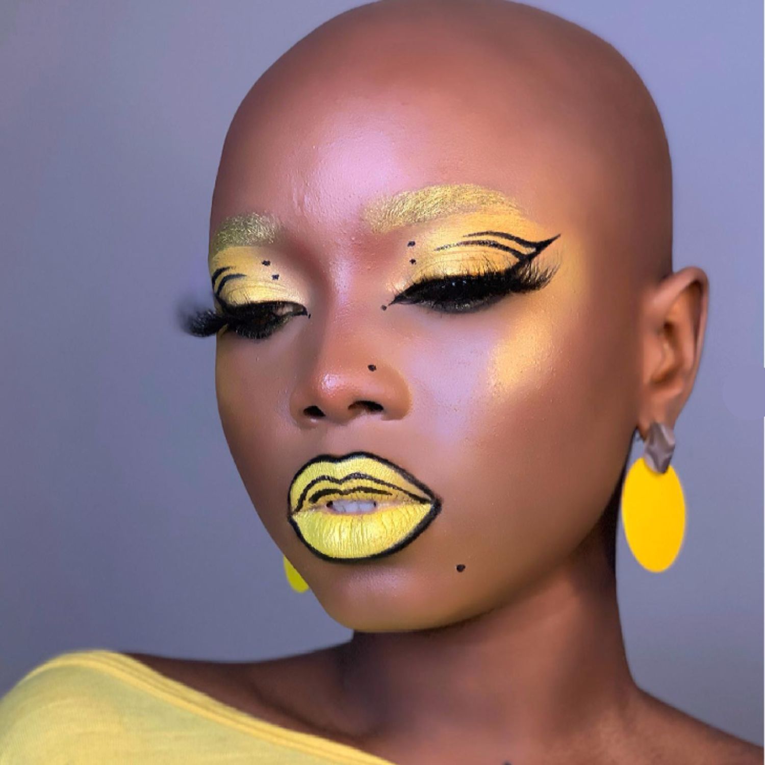 Graphic yellow and black lips and eyes.