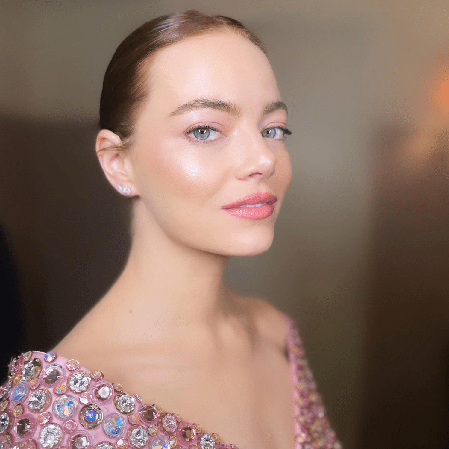 Emma Stone with glowy skin and pastel makeup