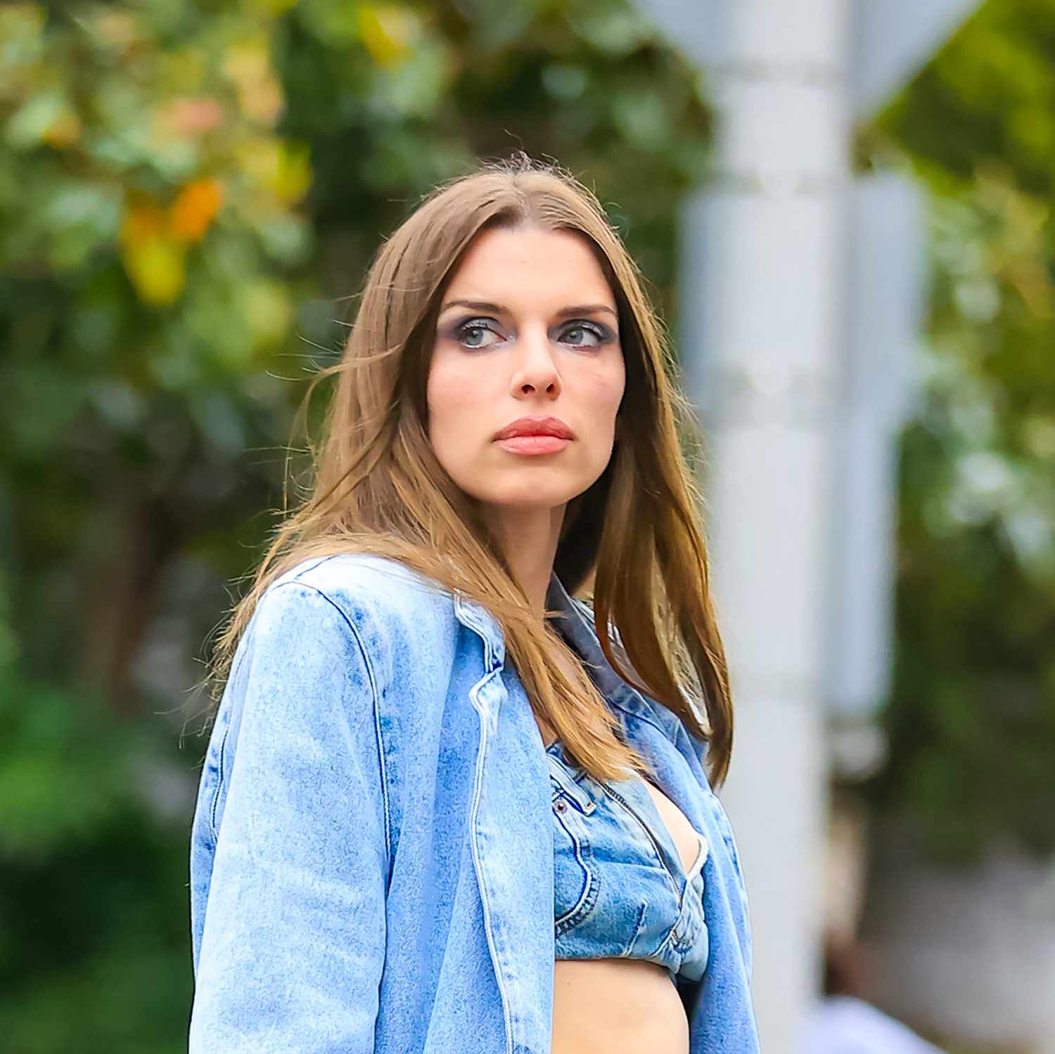 Julia Fox is seen outside in Los Angeles wearing blue smoky eyeshadow with prominently highlighted brow bone and pink lipstick with a matching denim outfit 