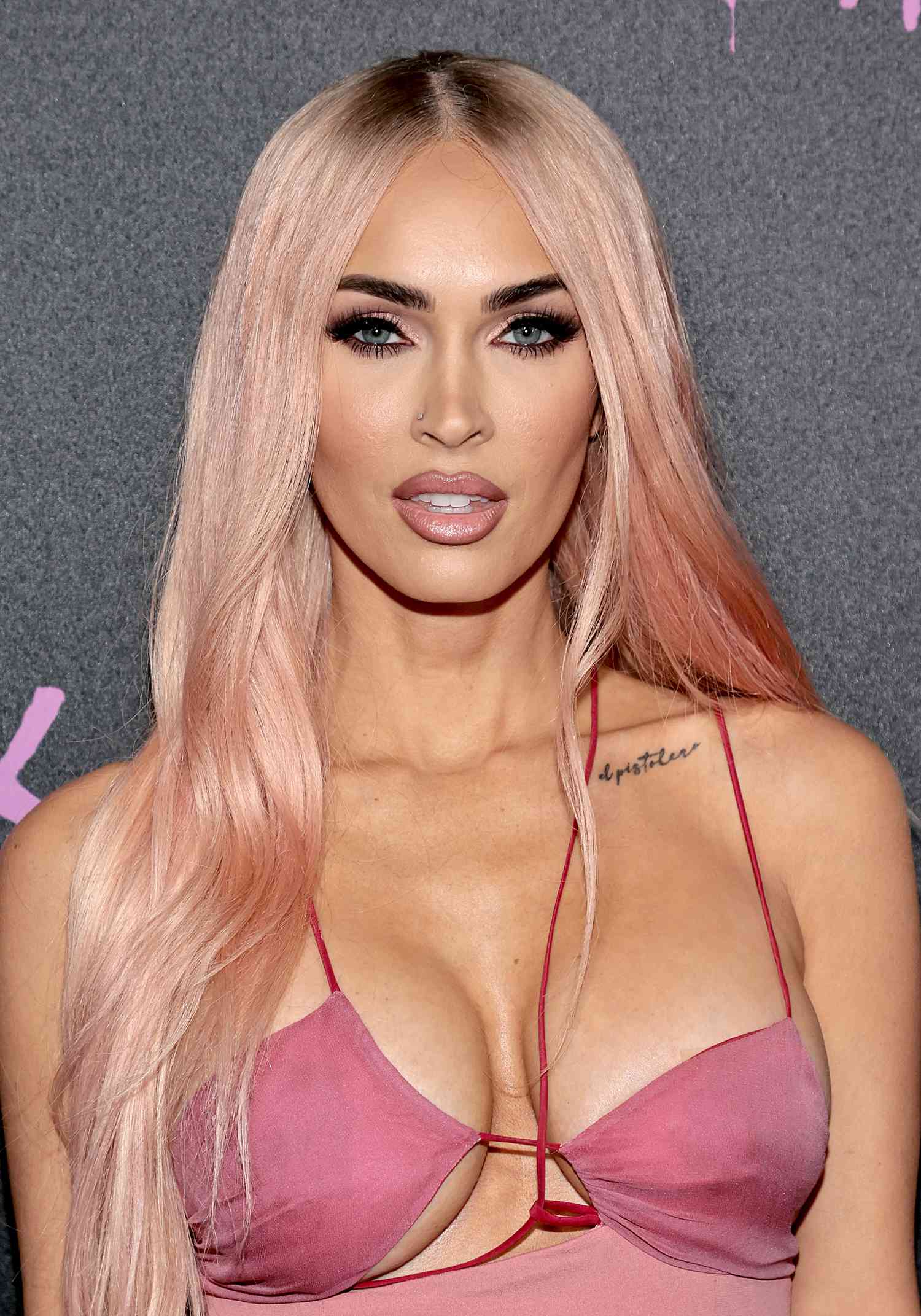 Megan Fox in baby pink hair and a matching, strappy pink dress while at the premiere of Life In Pink