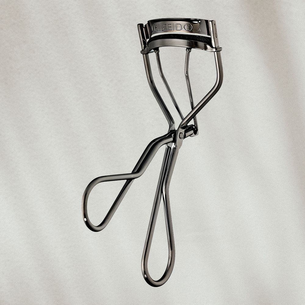 Eyelash curler on textured background