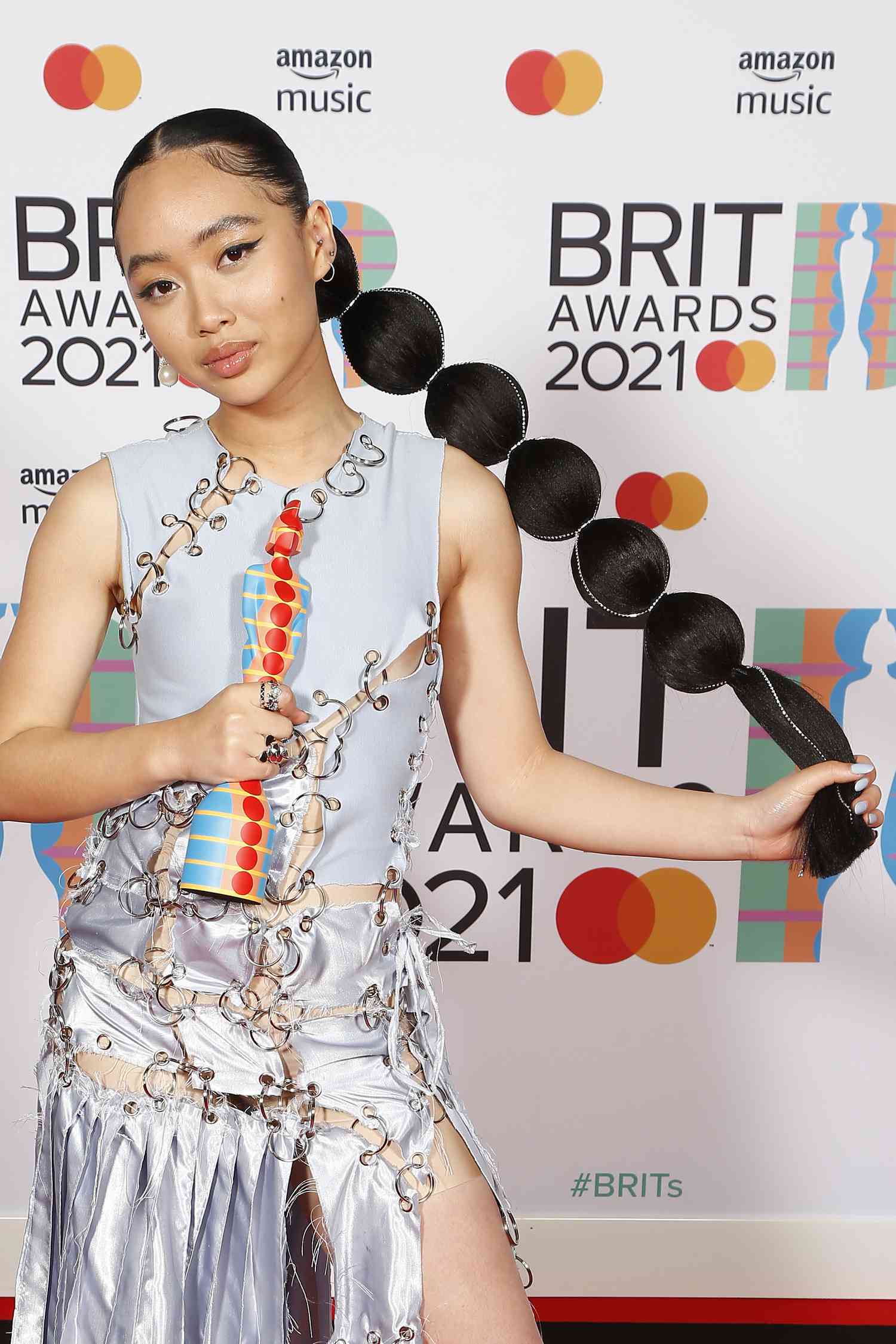 Singer Griff holds out a bejeweled bubble ponytail