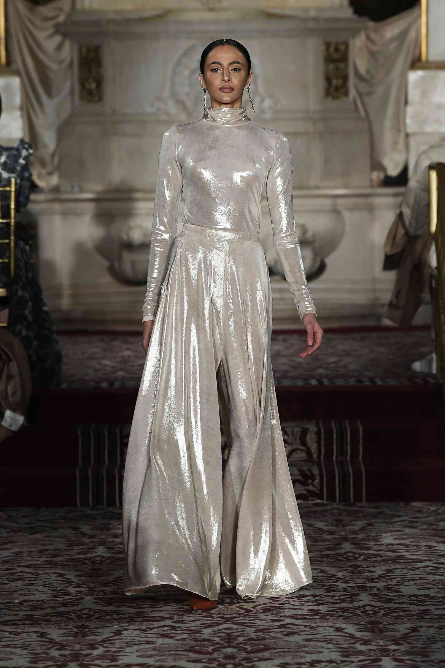 Model on the Christian Siriano runway show wearing a monochromatic metallic color look.