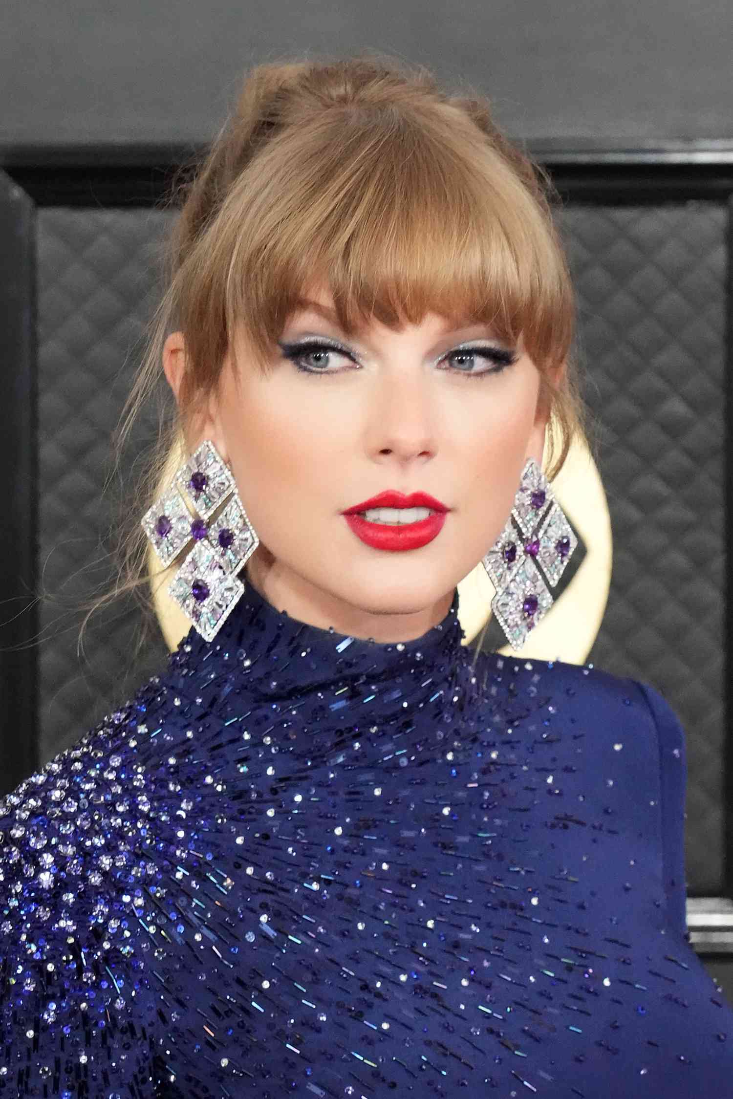 Taylor Swift with a bold red lip and cat-eye makeup at the 2023 Grammy Awards