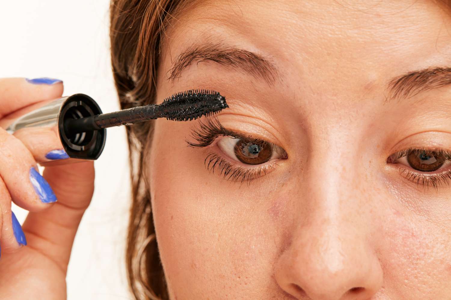 Closeup of a person applying L’Oréal Bambi Eye Waterproof Mascara to lashes