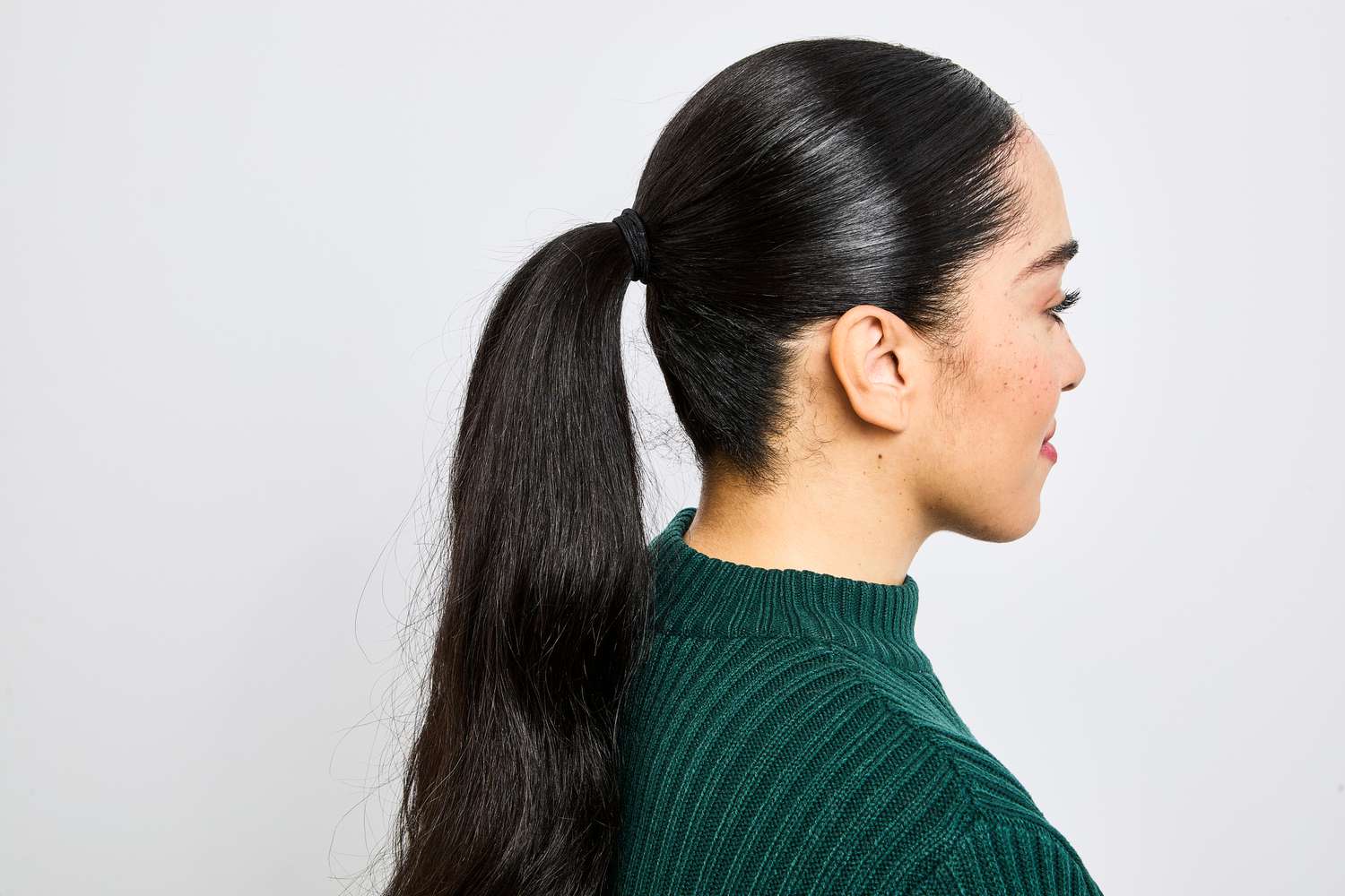 A person with their hair up in a ponytail after using Living Proof Style Lab Flex Hairspray