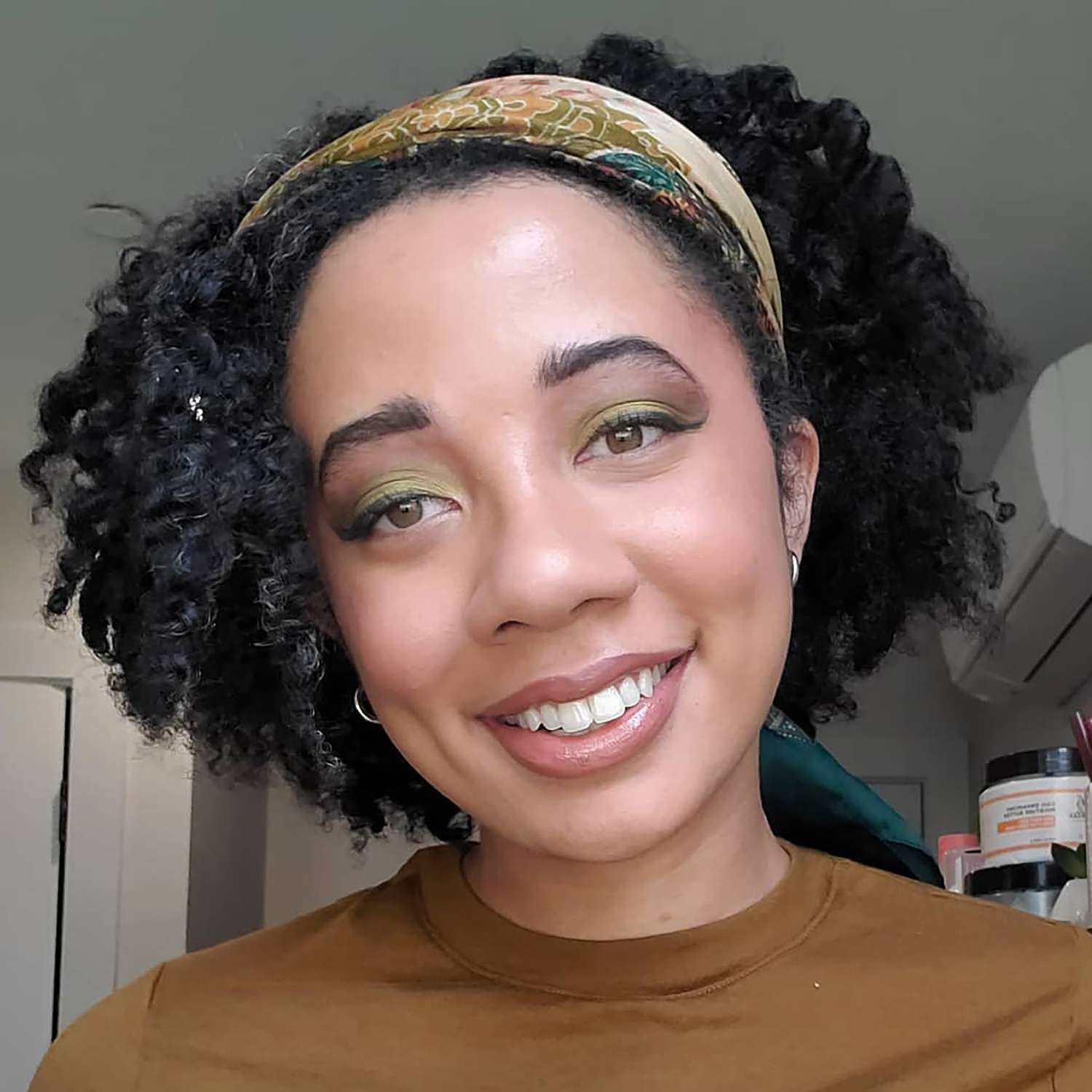 Close up of Byrdie Beauty Editor Eden Stuart in green and brown matcha latte makeup