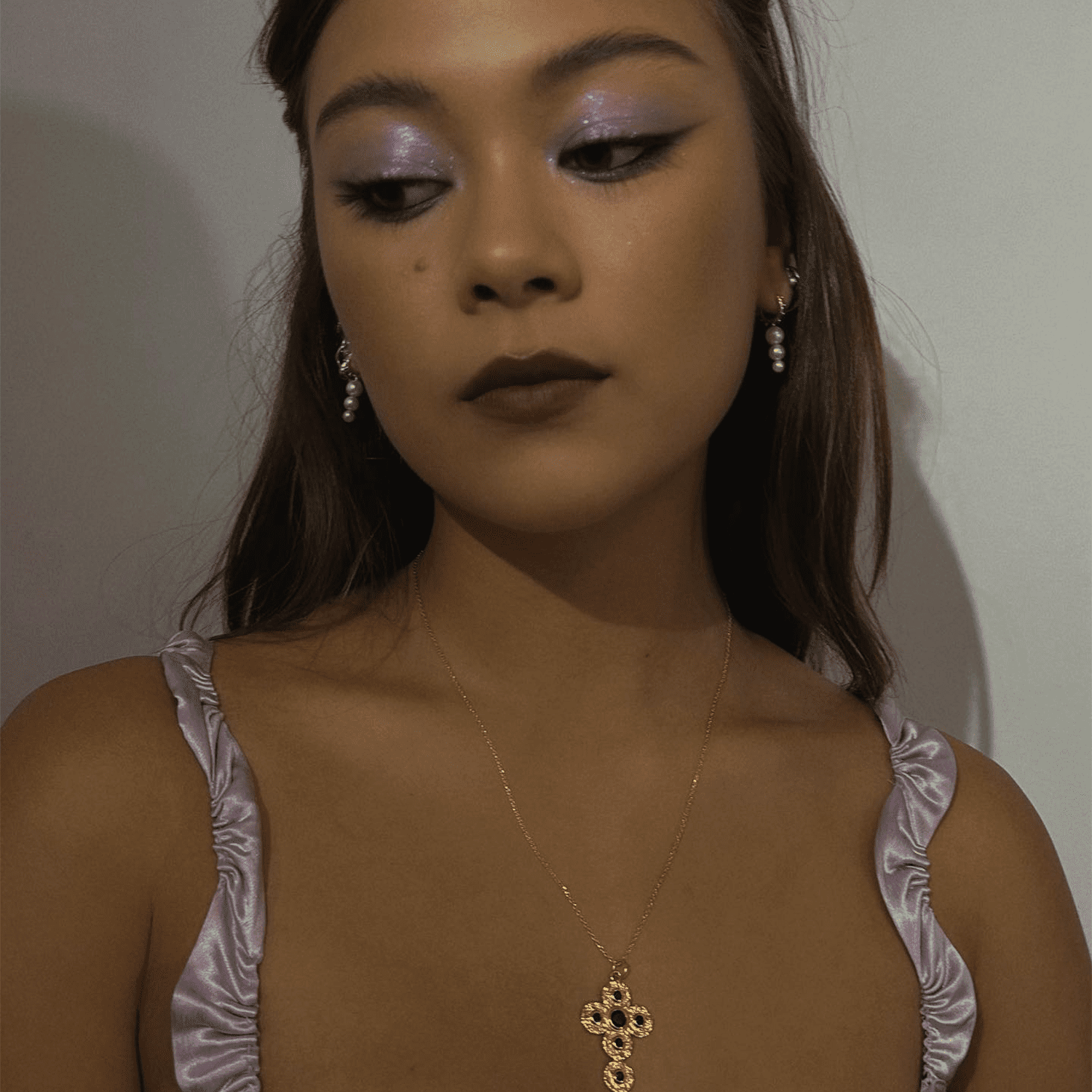 Woman wearing sparkly eyeshadow and dark lipstick