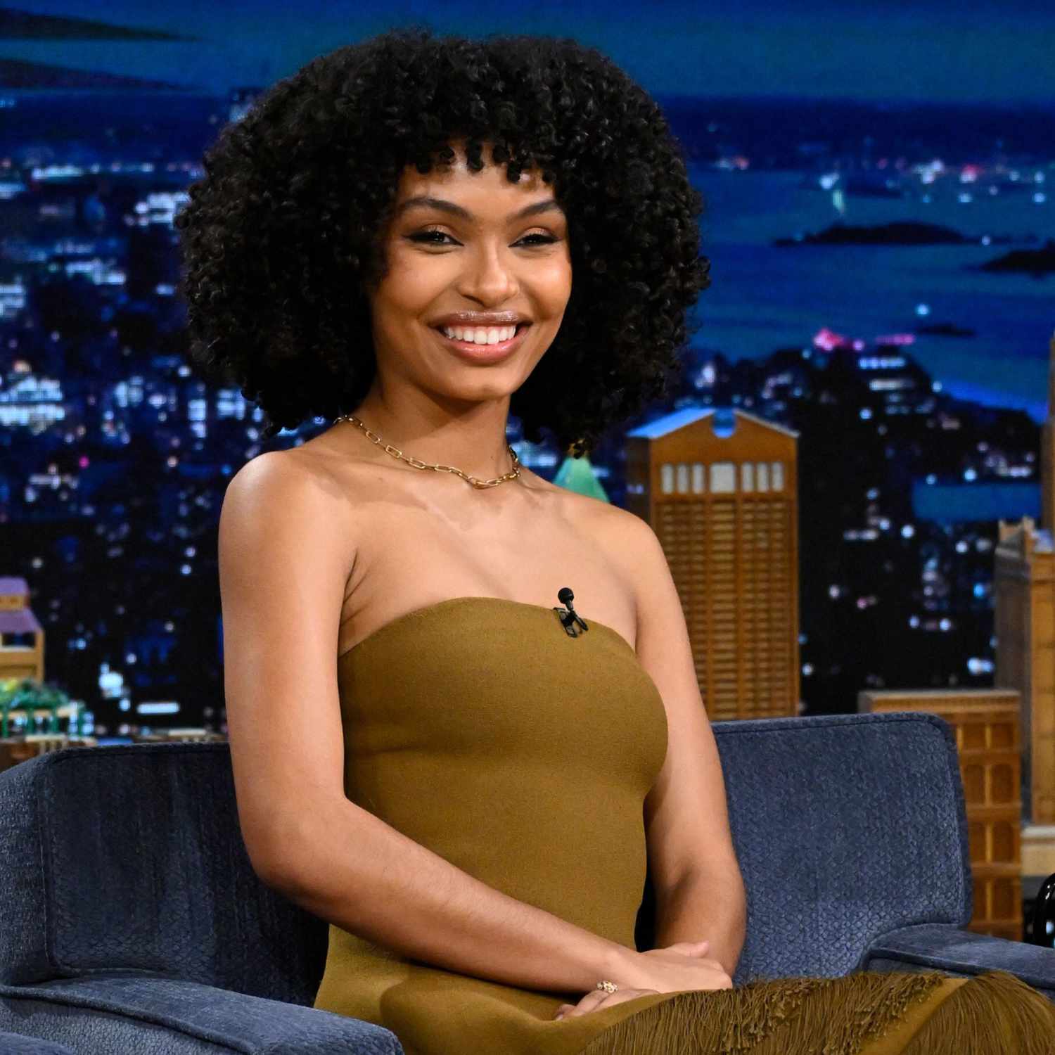 Yara Shahidi with a bob-length curly Afro hairstyle featuring curly bangs