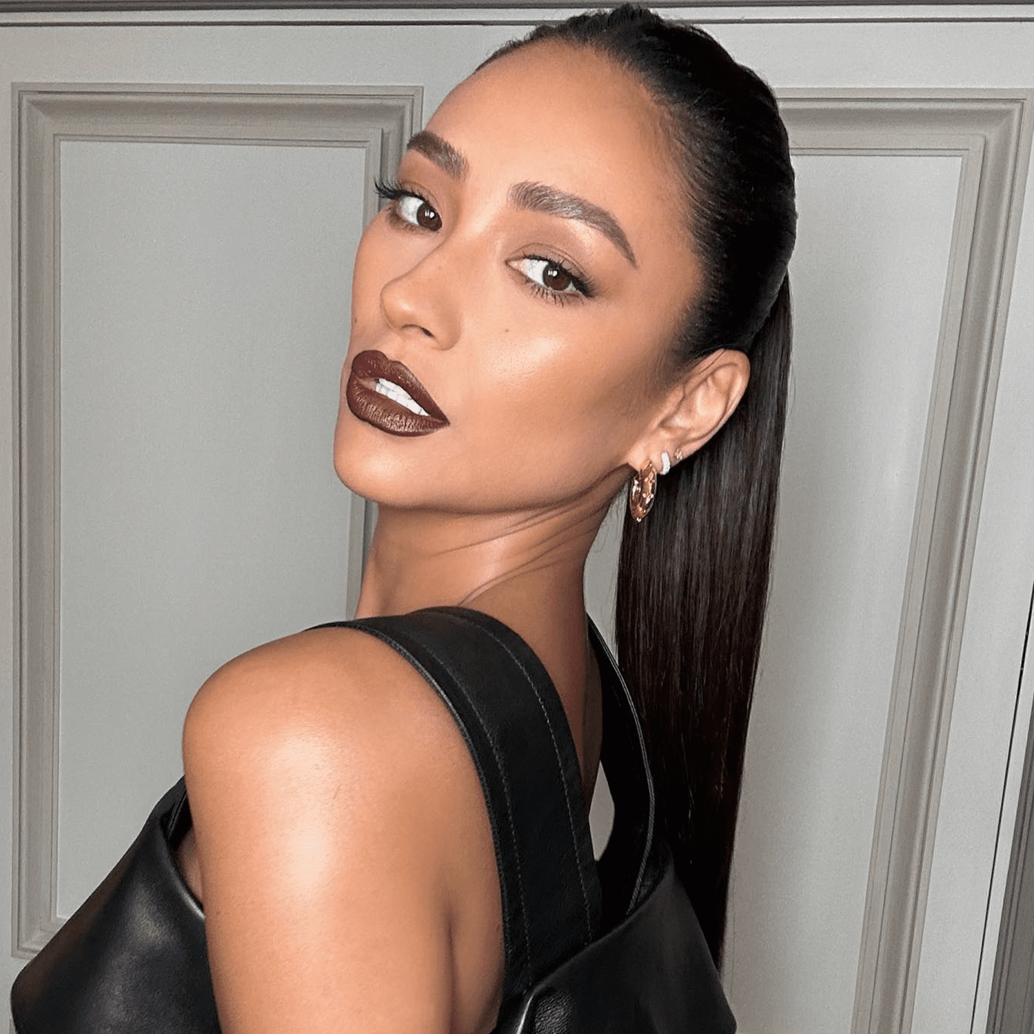 Shay Mitchell wearing full brows and dark lipstick