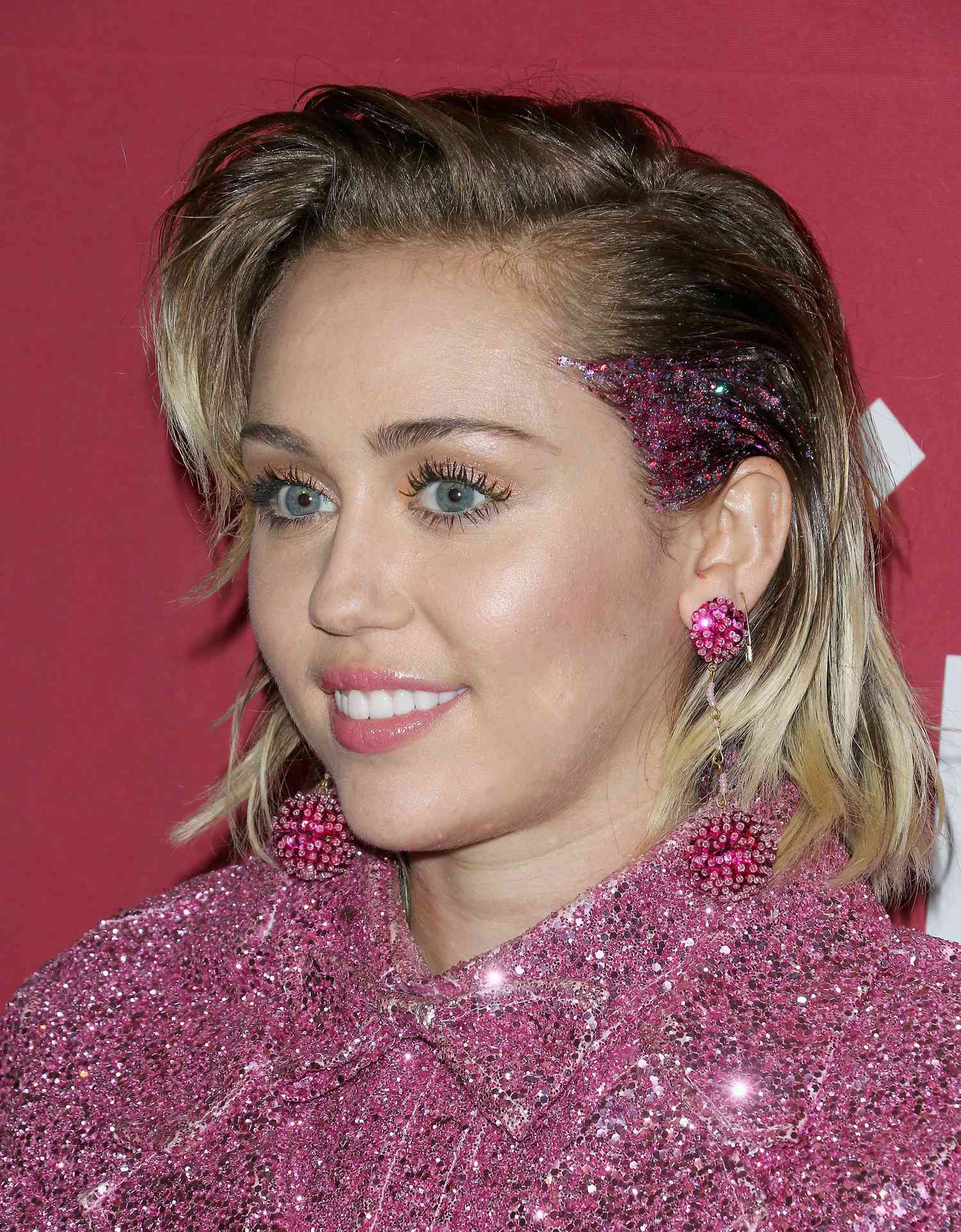 Miley Cyrus wears pink glitter to a (RED) Event