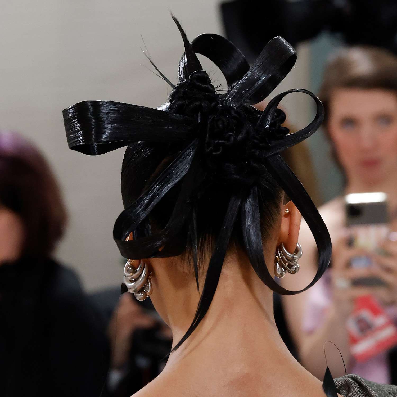 Back of FKA Twigs' braided bun hairstyle with spiky ends and bows for the 2023 Met Gala