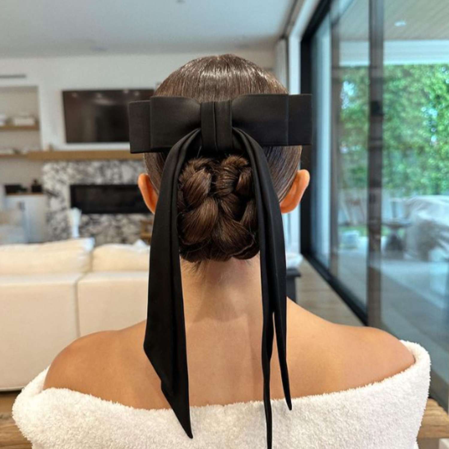 Olivia Culpo in a braided ballet bun with a bow.