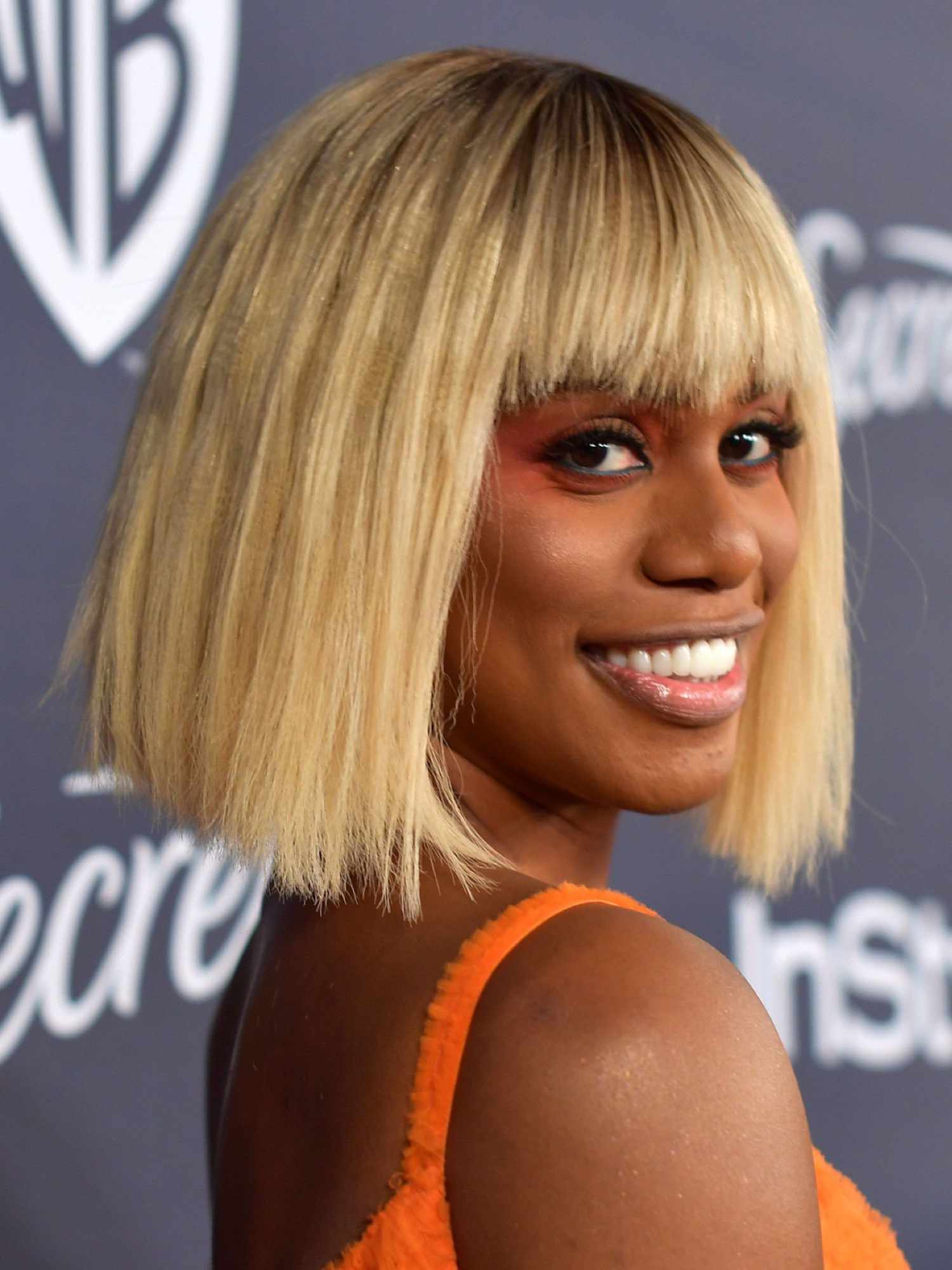 Close up of Laverne Cox with a blunt cut blonde bob