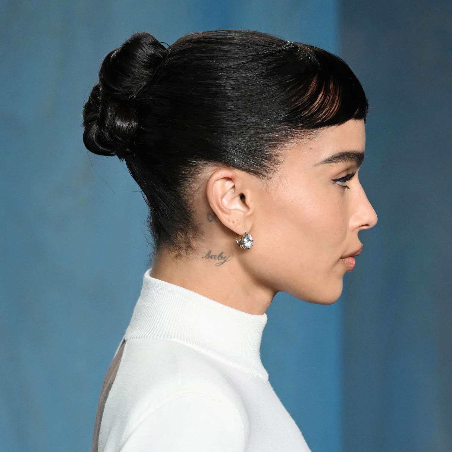 Zoe Kravitz wears a twisted bun hairstyle with baby bangs to the 2022 Vanity Fair Oscars afterparty