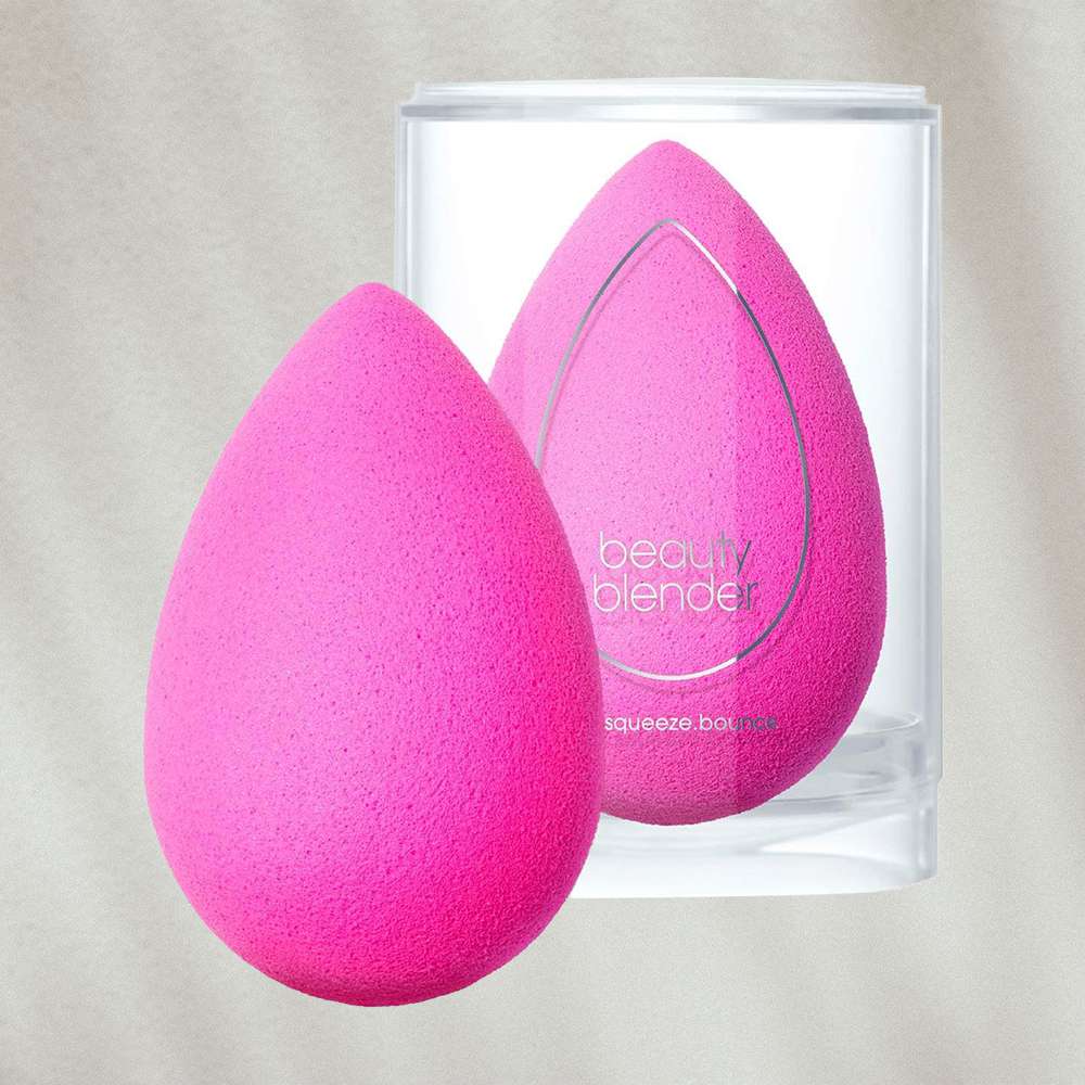 Beauty blender sponge and container on textured background