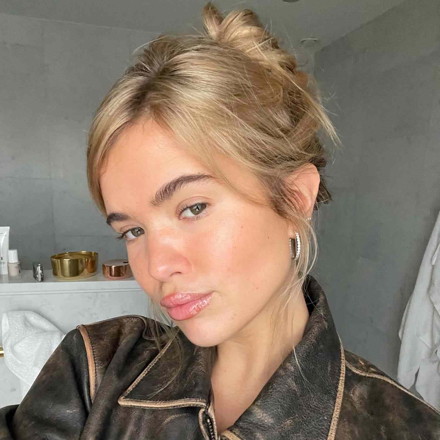 Matilda Djerf wears a light, beige-toned linen blonde updo and minimal makeup