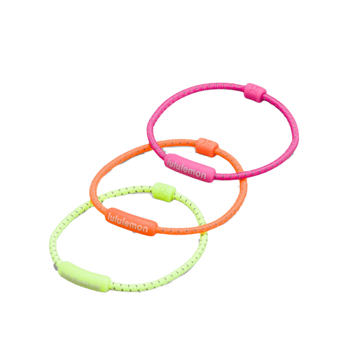 Lululemon Silicone Hair Ties in highlighter yellow, orange, and pink