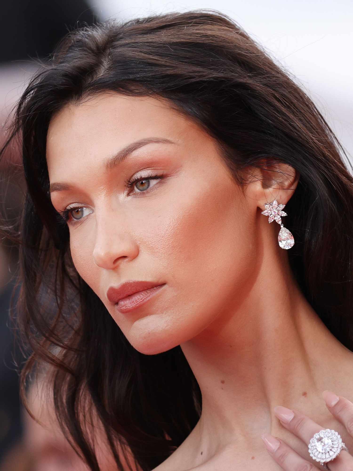 Bella Hadid with a radiant makeup look and thin '90s eyebrows