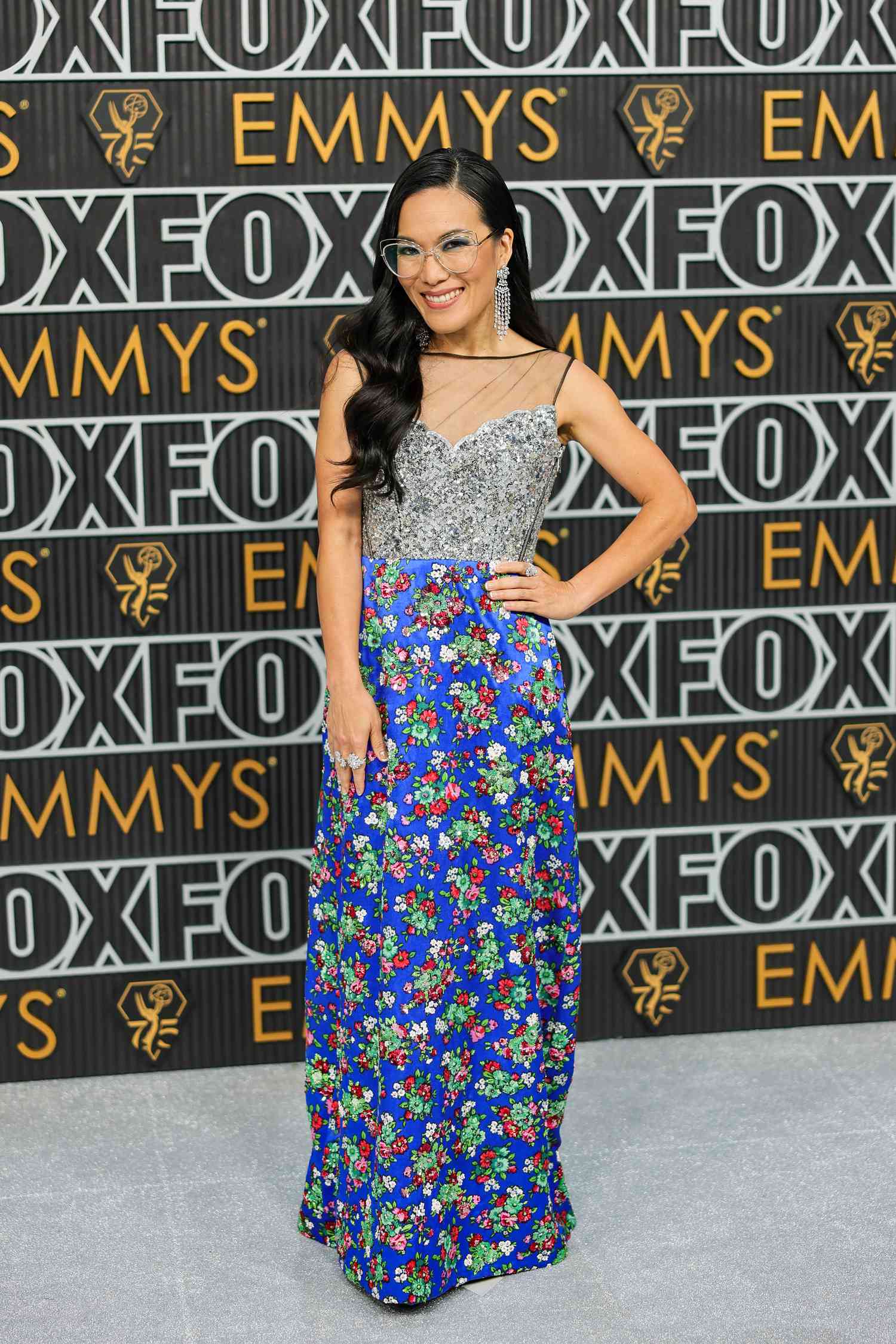 Ali Wong at the Emmys with dark denim eyeshadow and a Louis Vuitton gown