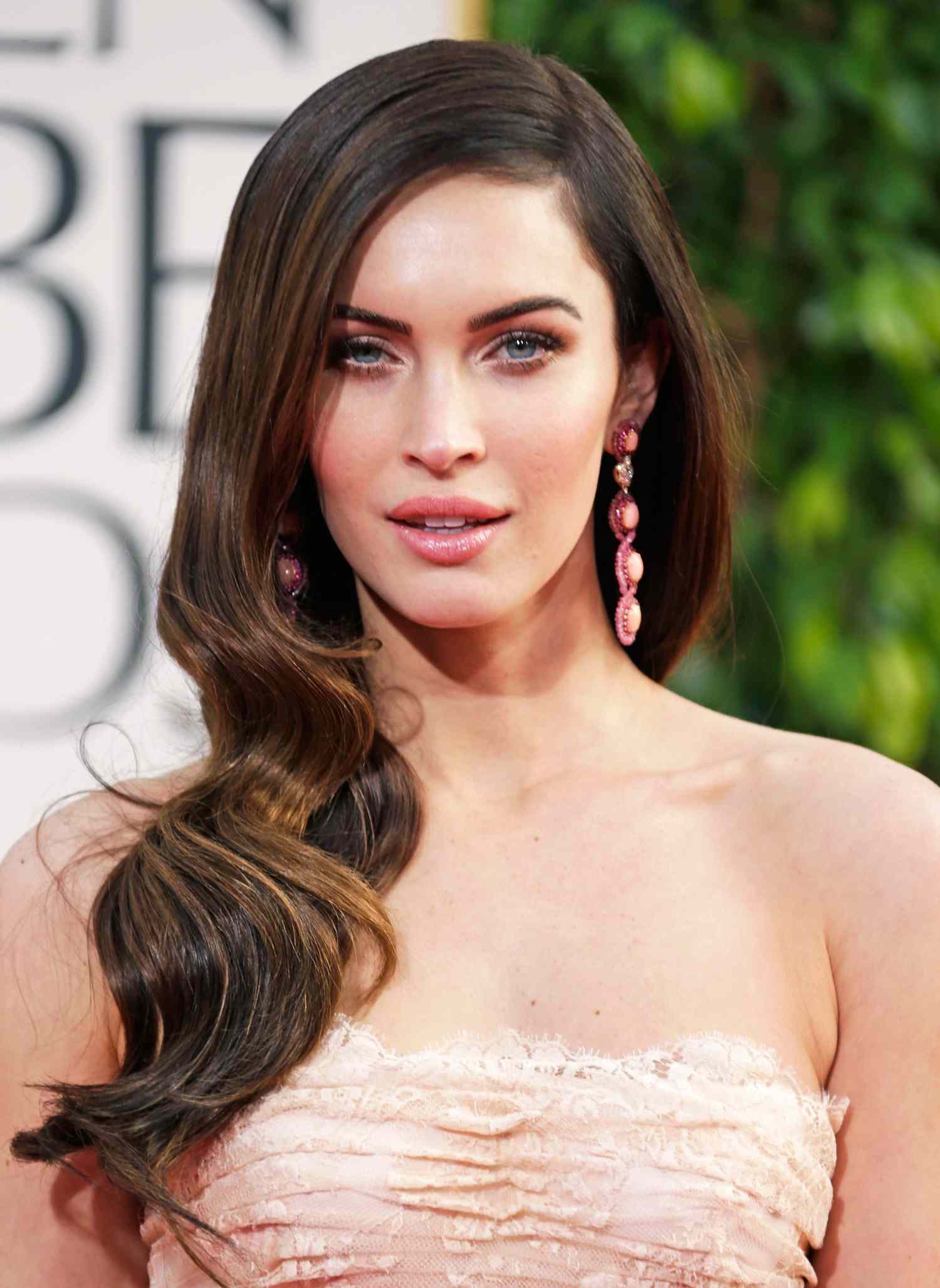 Megan Fox with brown hair and a lace dress while at 70th Golden Globes.