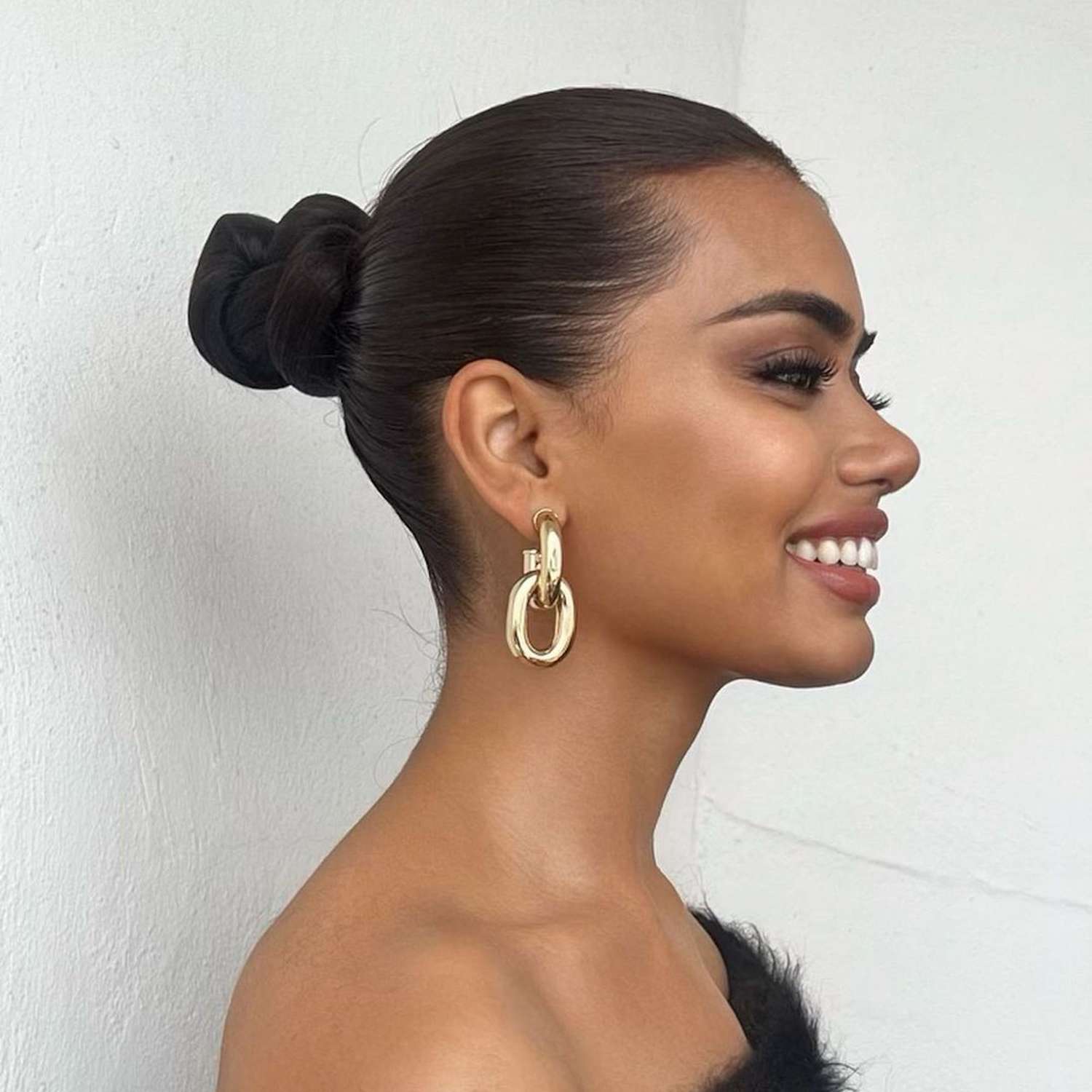 Model wears slicked-back twist bun