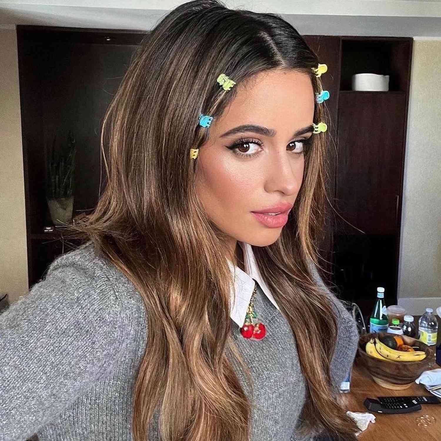 Camilla Cabello wearing small blue, green, and yellow clips 