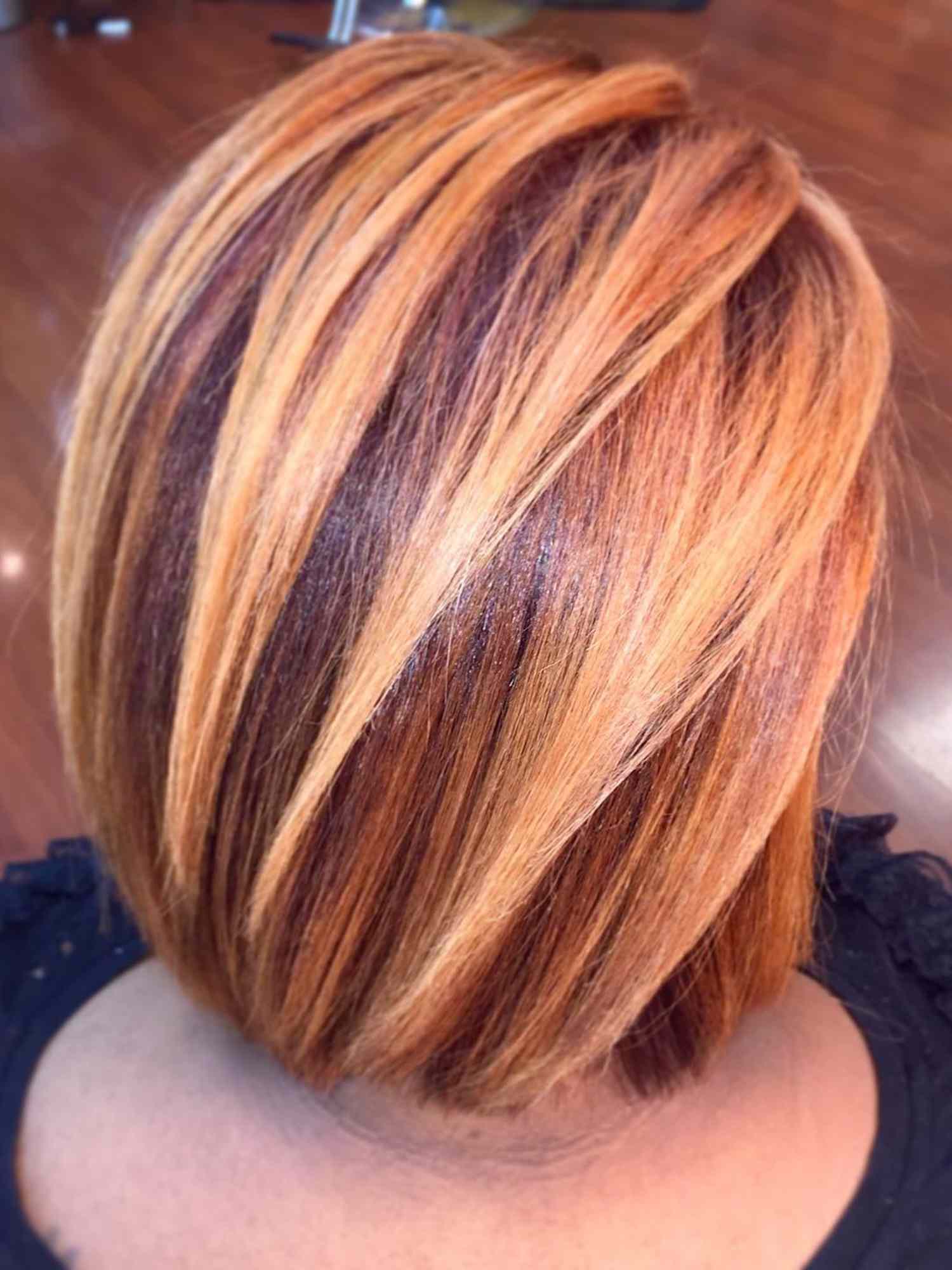 Back view of woman with ginger bob hairstyle with highlights