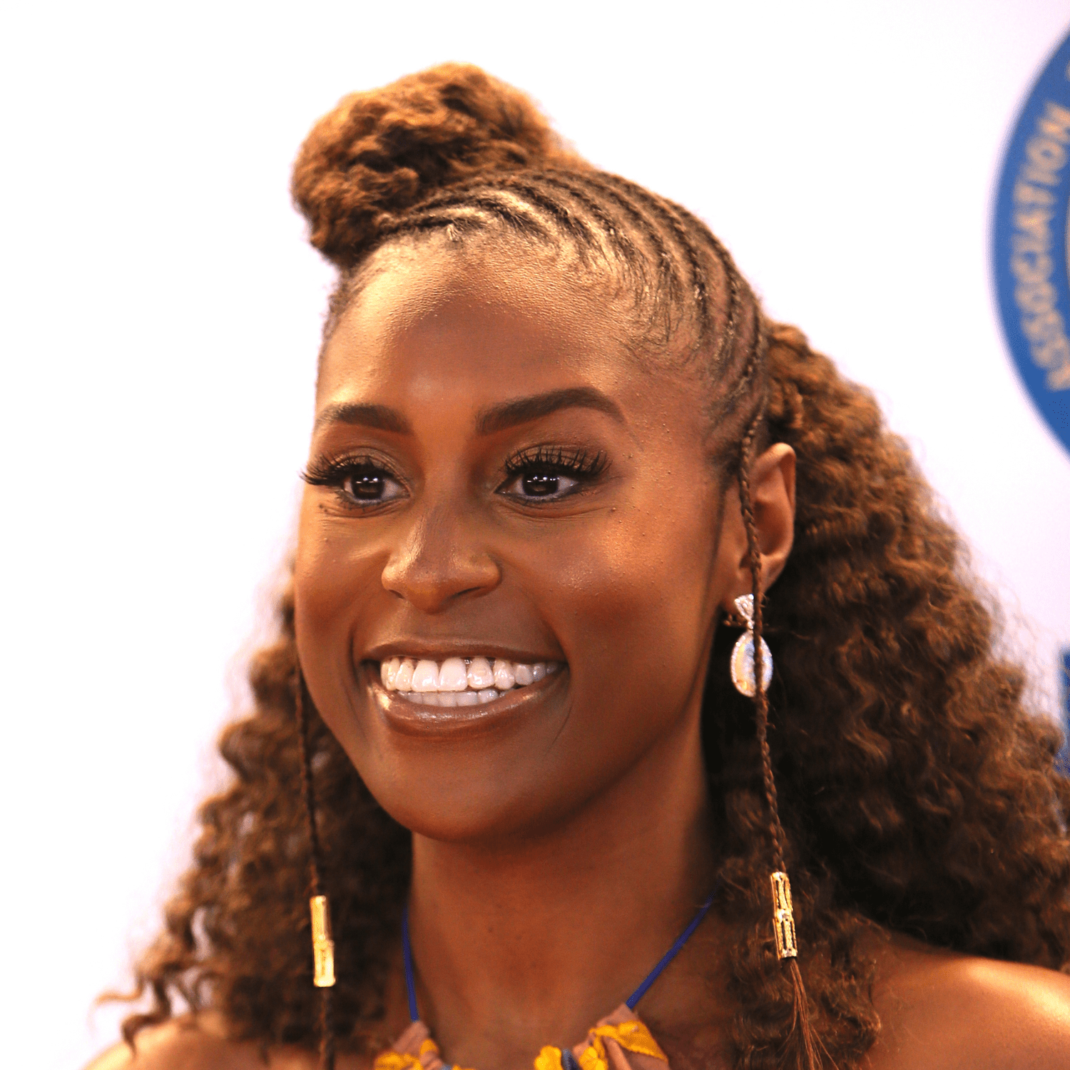 Issa Rae wearing cornrows and curls hairstyle on natural hair