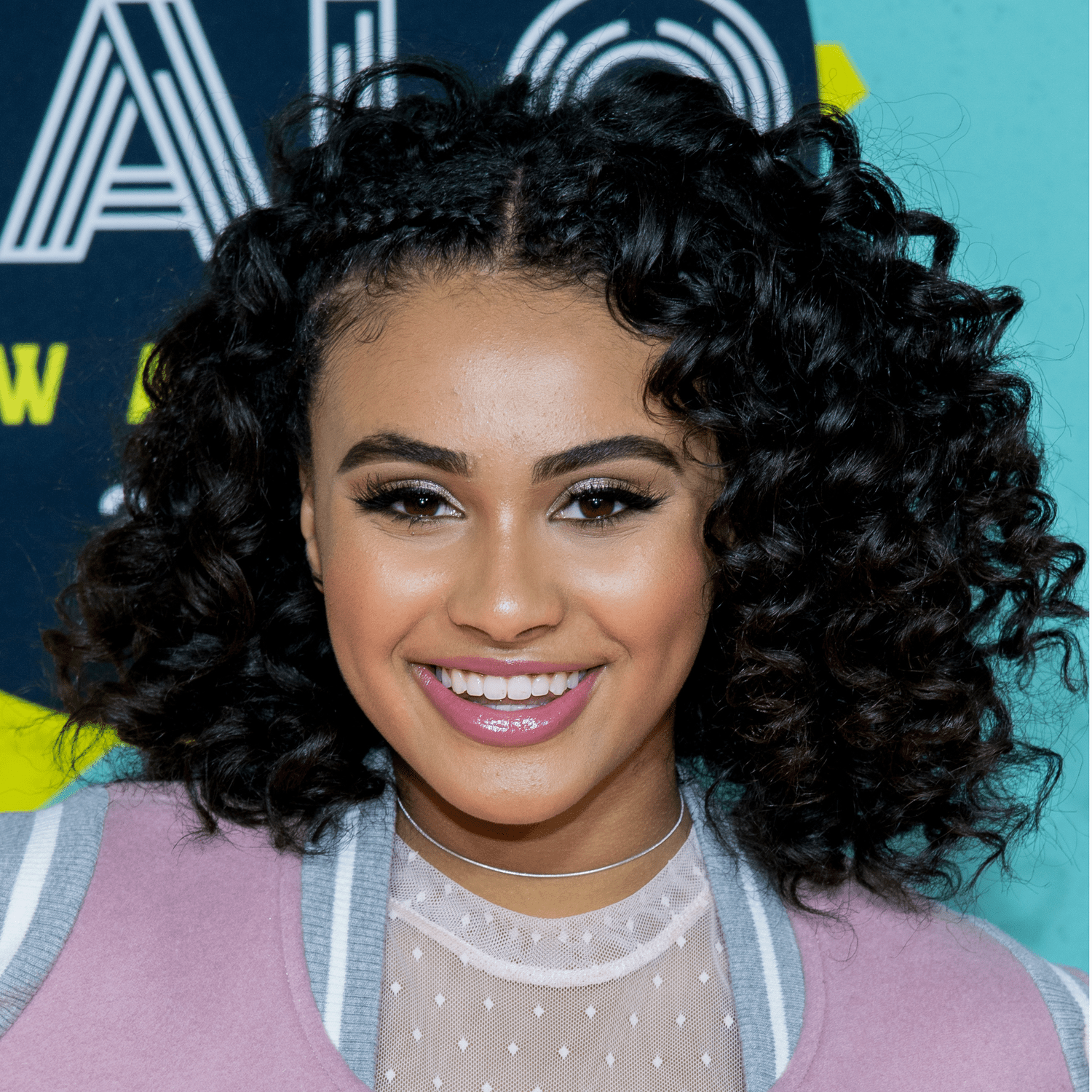 Daniella Perkins wearing curly bob with cornrows hairstyle