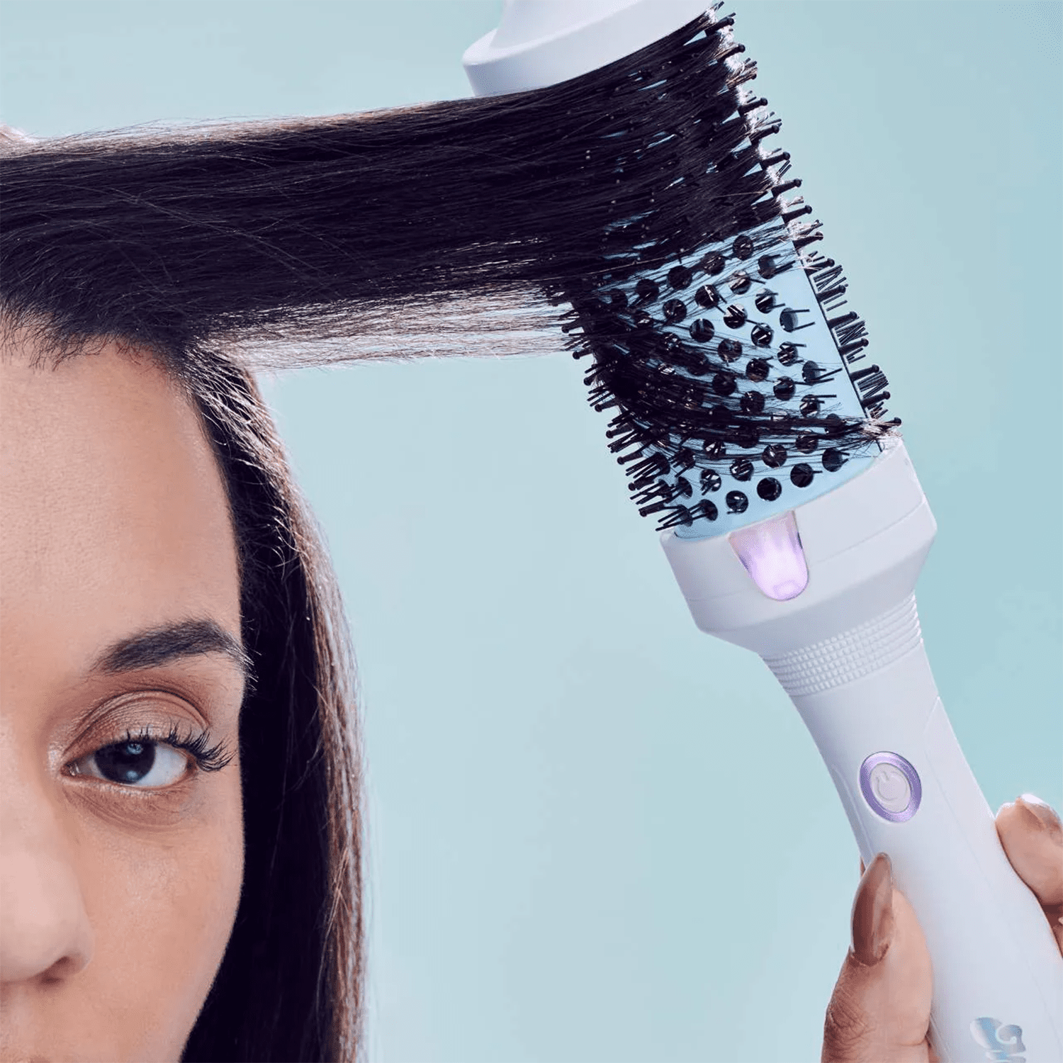 Woman using the Mane Its Giving Body Thermal Hot Brush