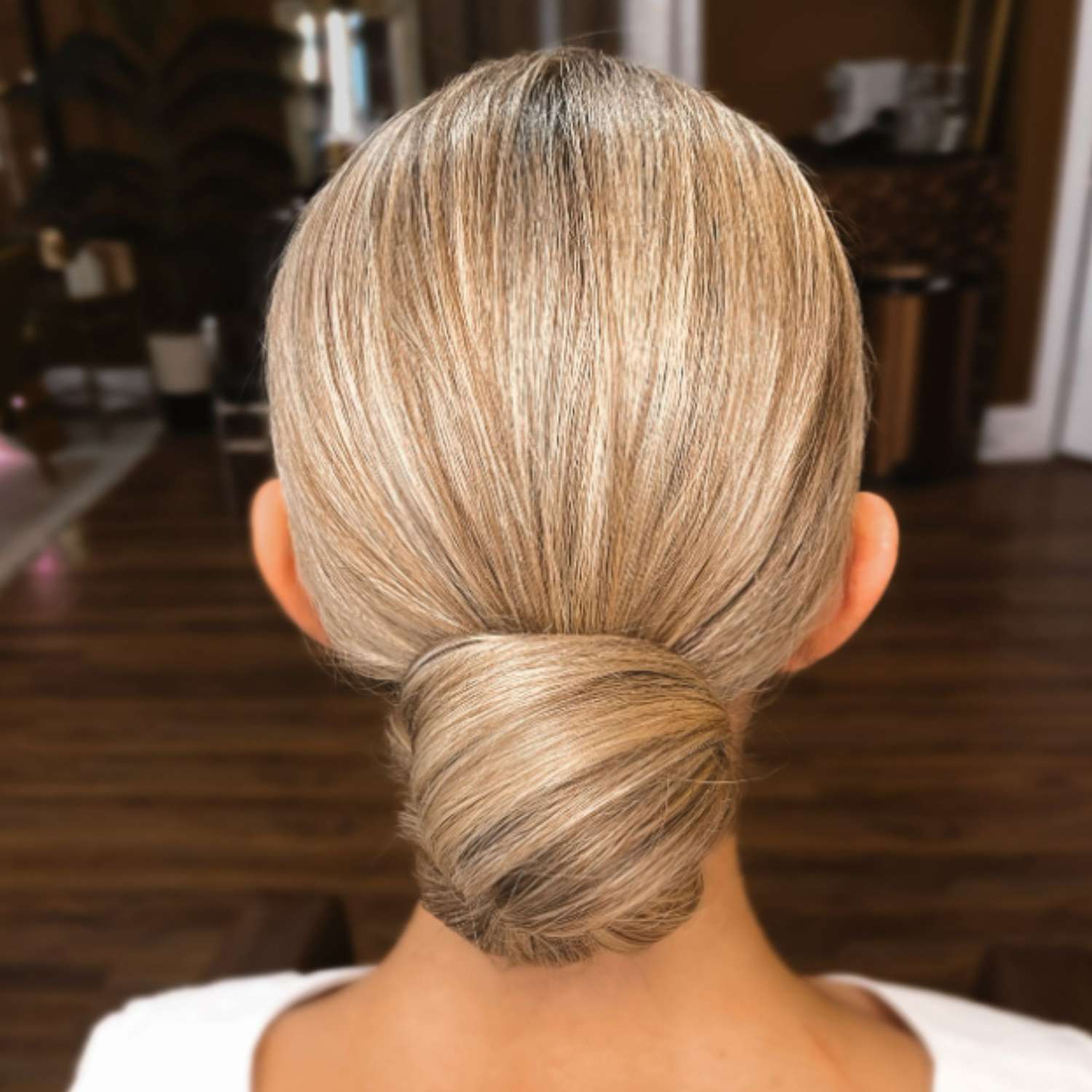 Low slicked-back sock bun.