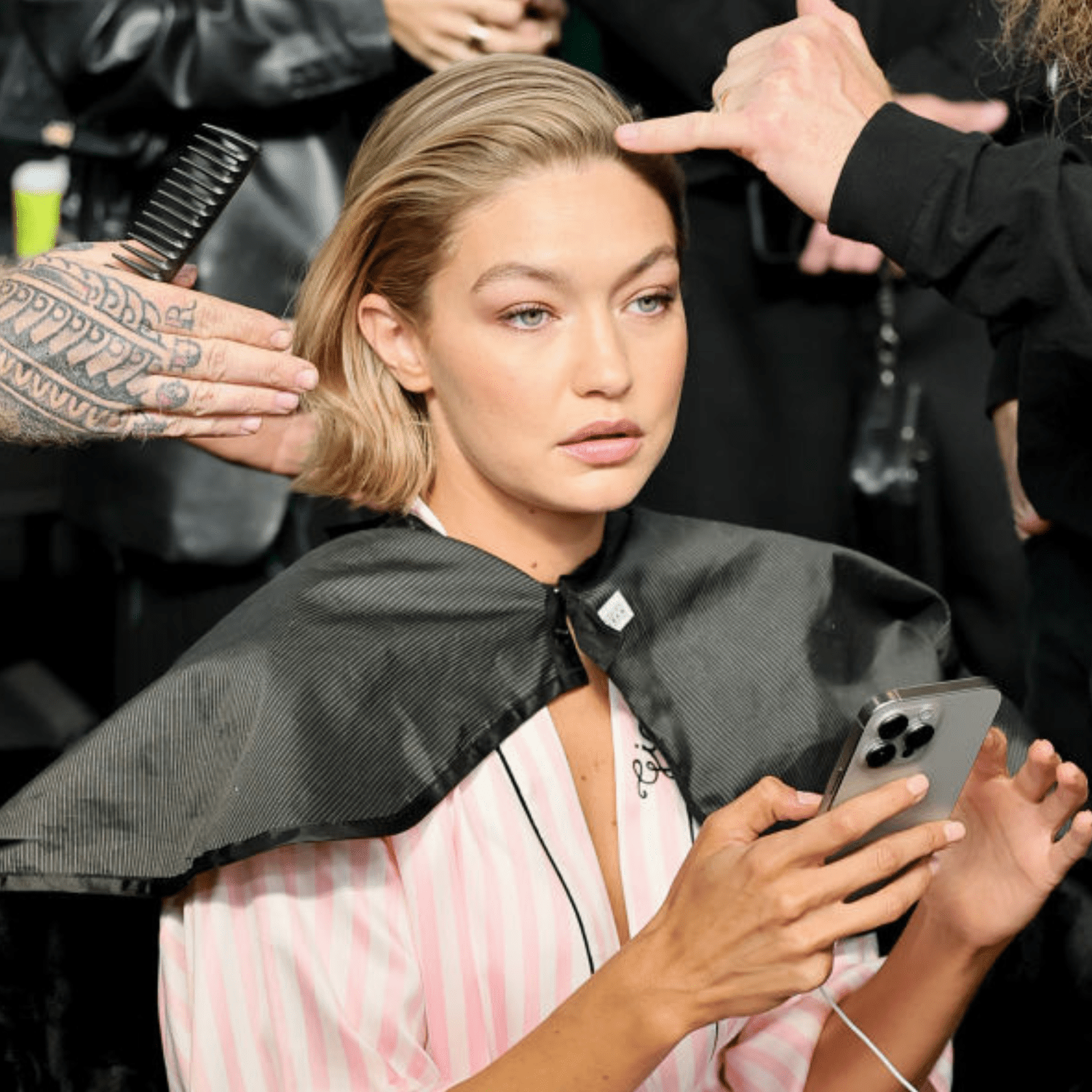 Gigi Hadid at the 2024 Victoria's Secret Fashion Show, getting her hair and makeup done backstage.