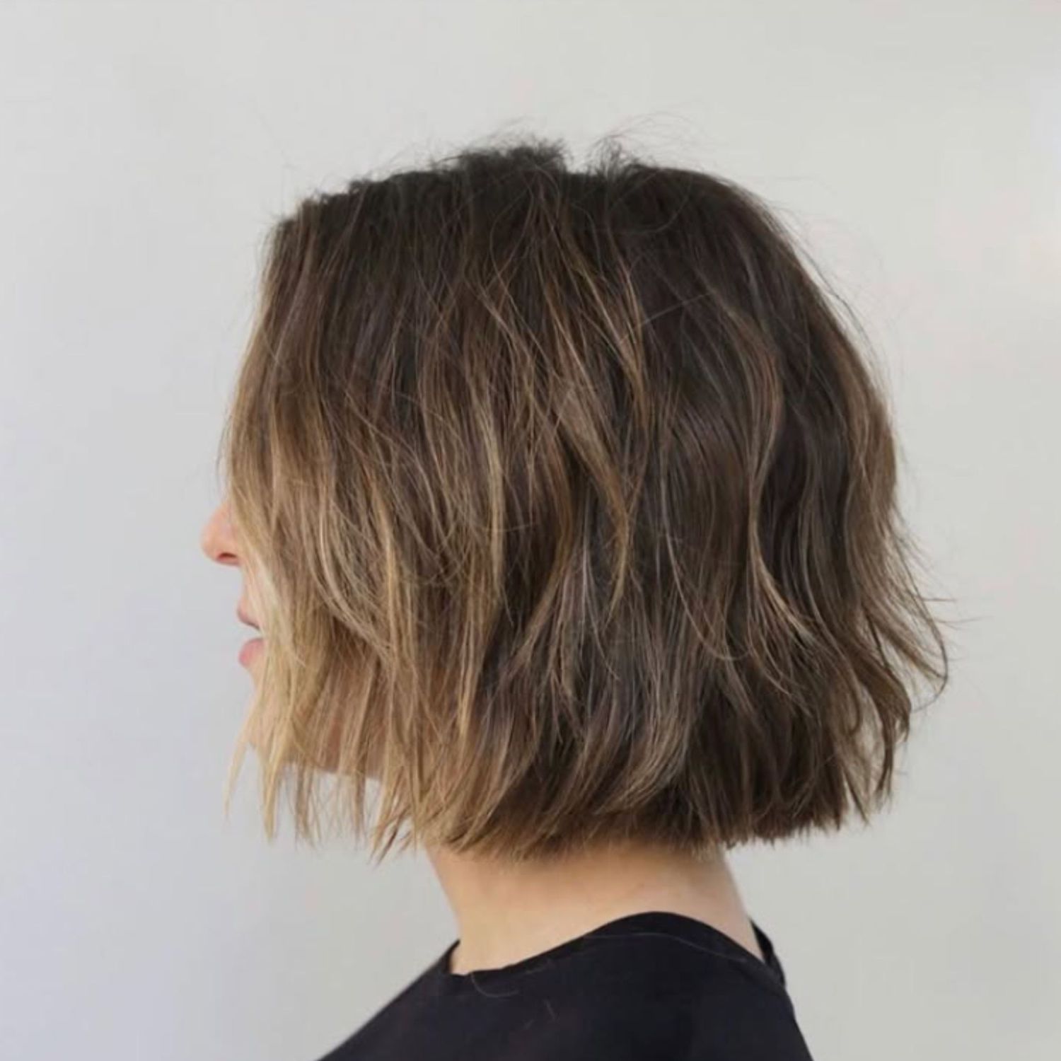 Short, bob-length hair with subtle caramel balayage.