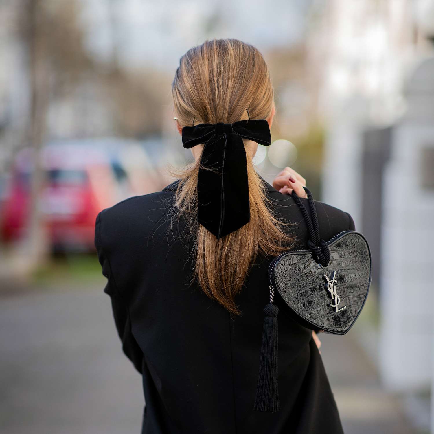 short hair pulled into a low ponytail with a bow