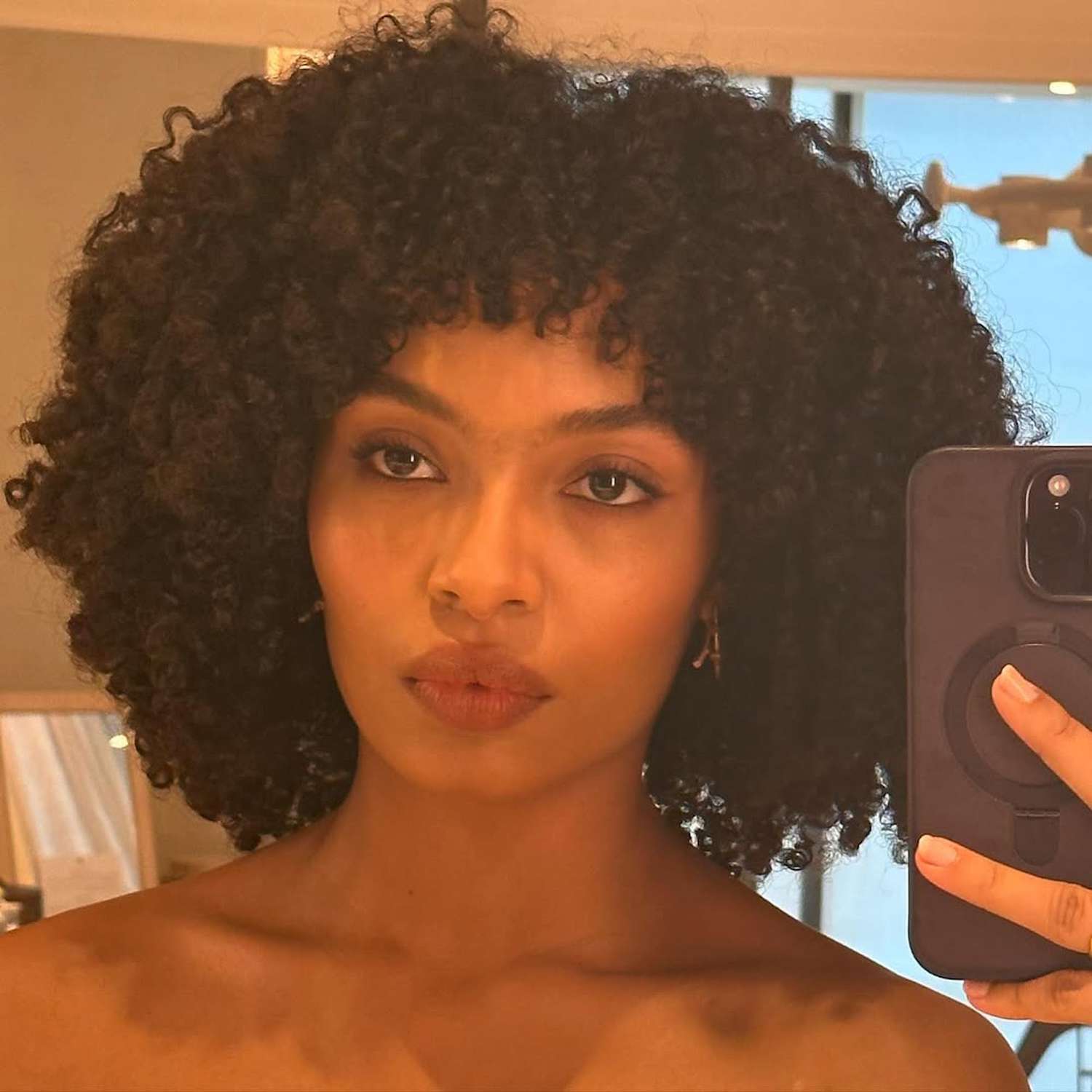 Yara Shahidi with curly chin-length hair