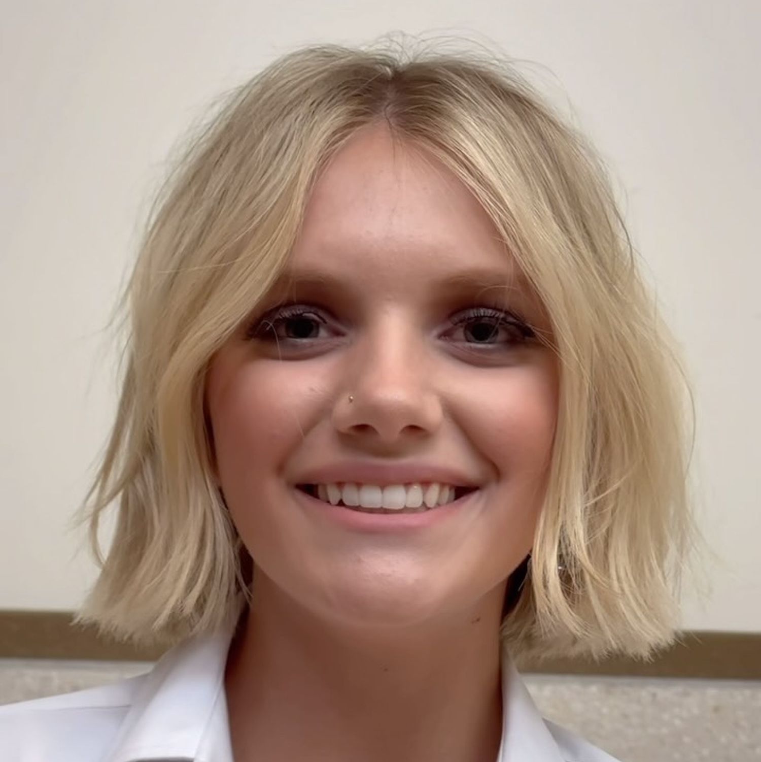 Woman with blonde choppy chin-length haircut