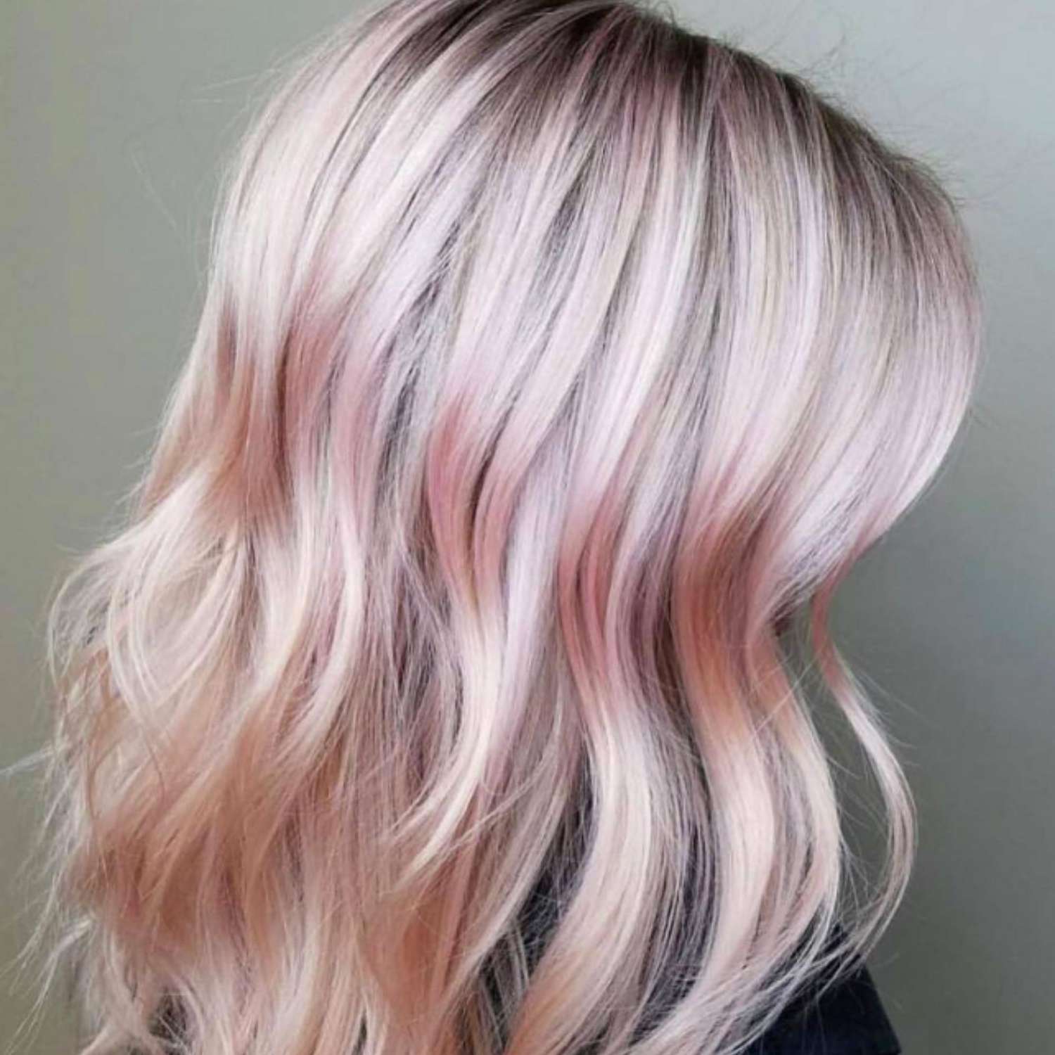 Baby pink highlights on blonde hair.