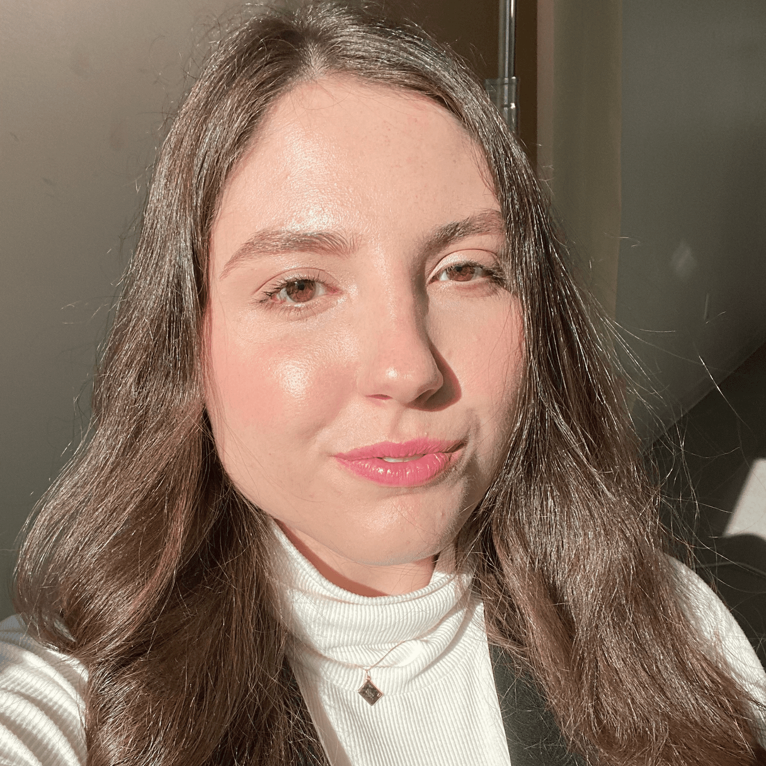 Byrdie associate editor Abby Dupes wearing minimal makeup in a closeup selfie.