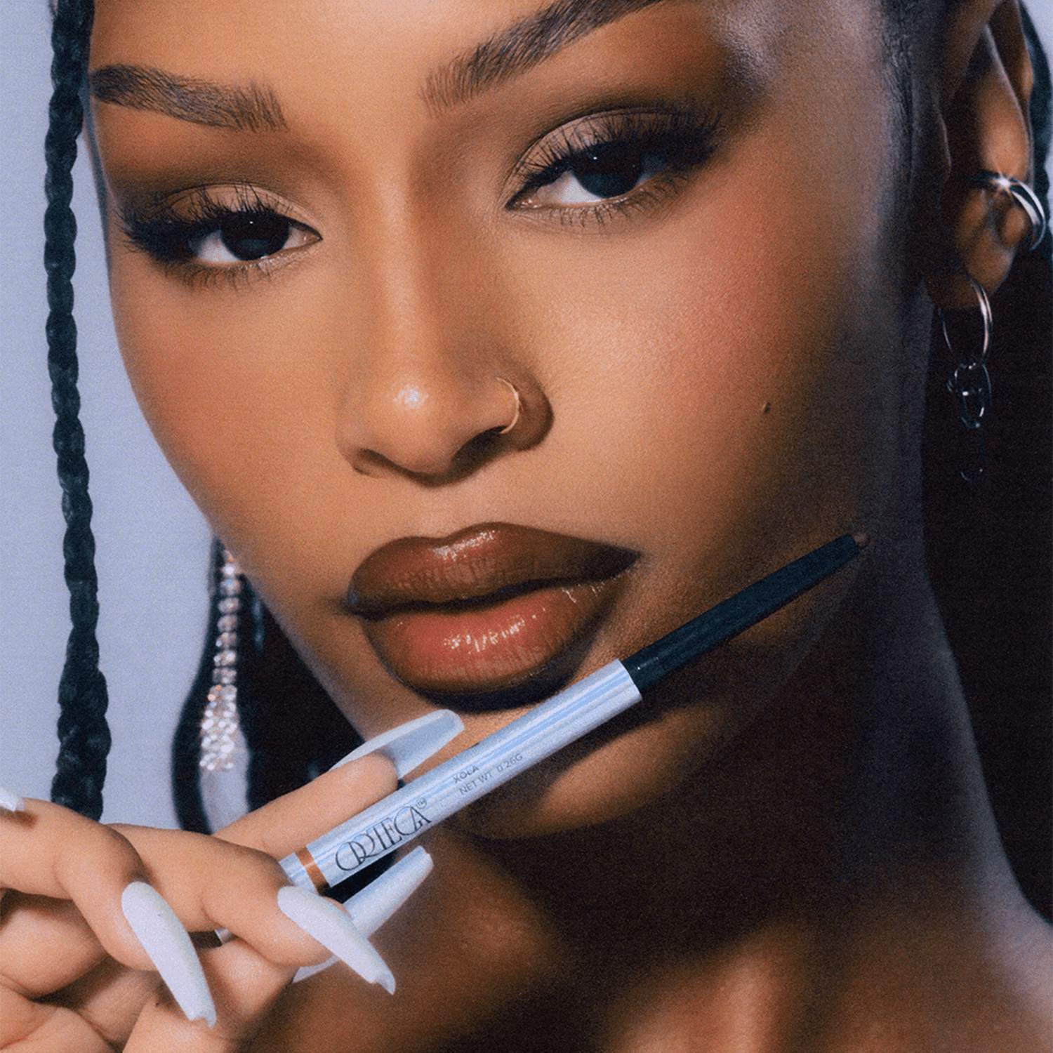 Model holding the Ortega lip liner