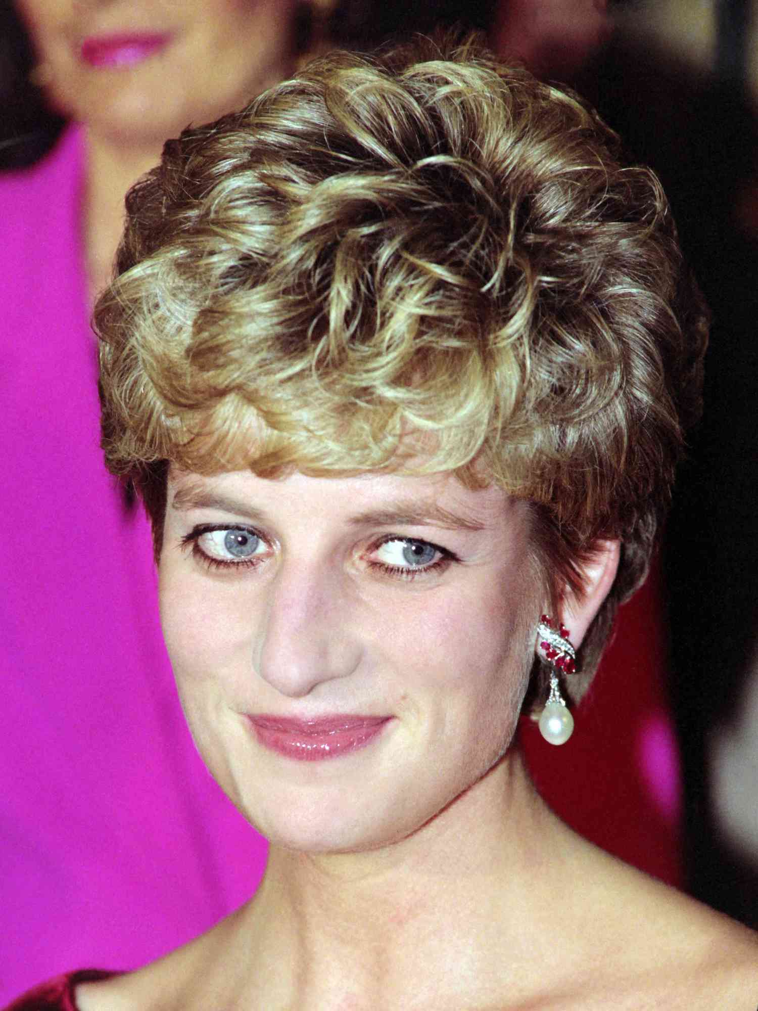 Princess Diana with a curly short hairstyle and pearl drop earrings