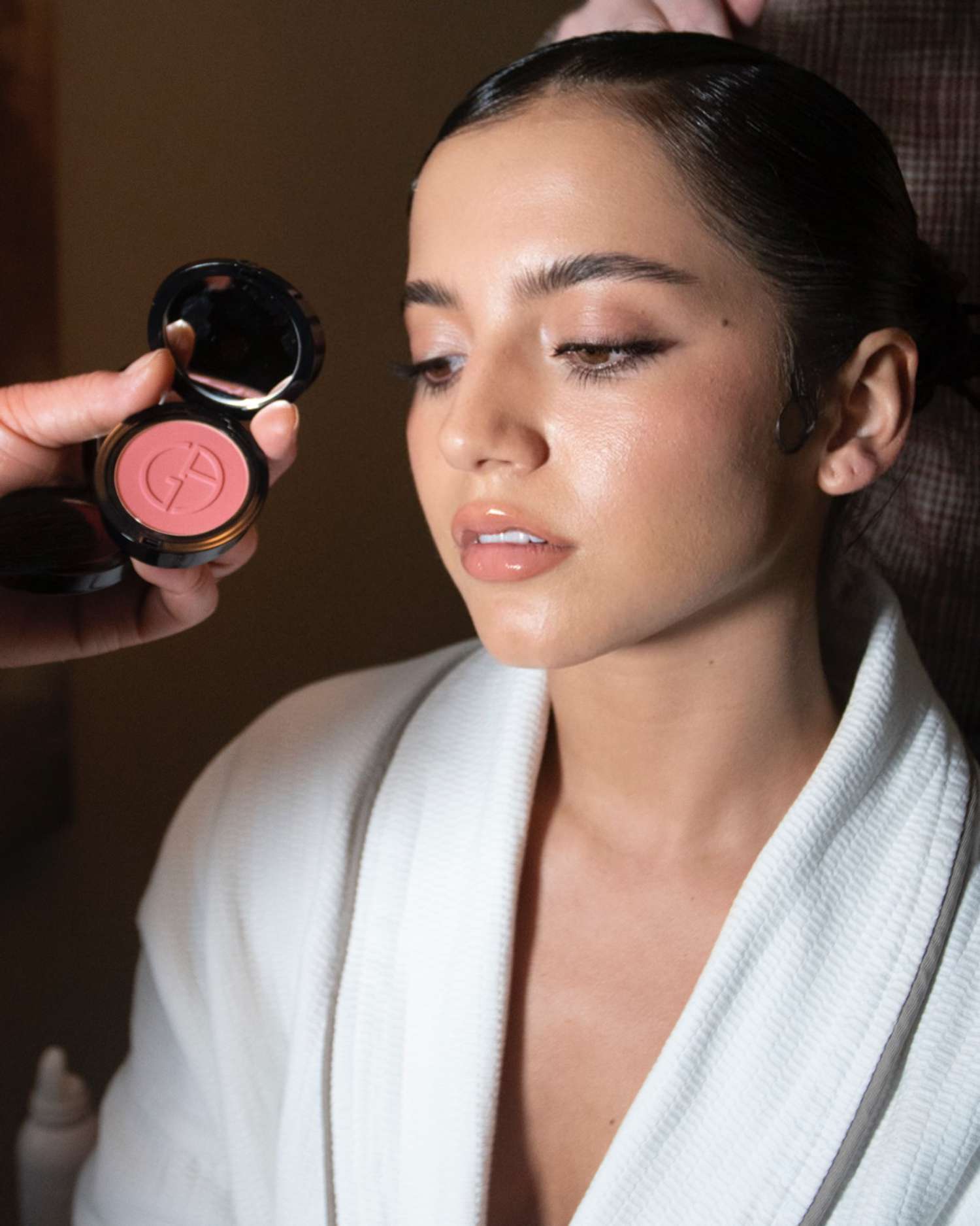 Isabela Merced getting her makeup done