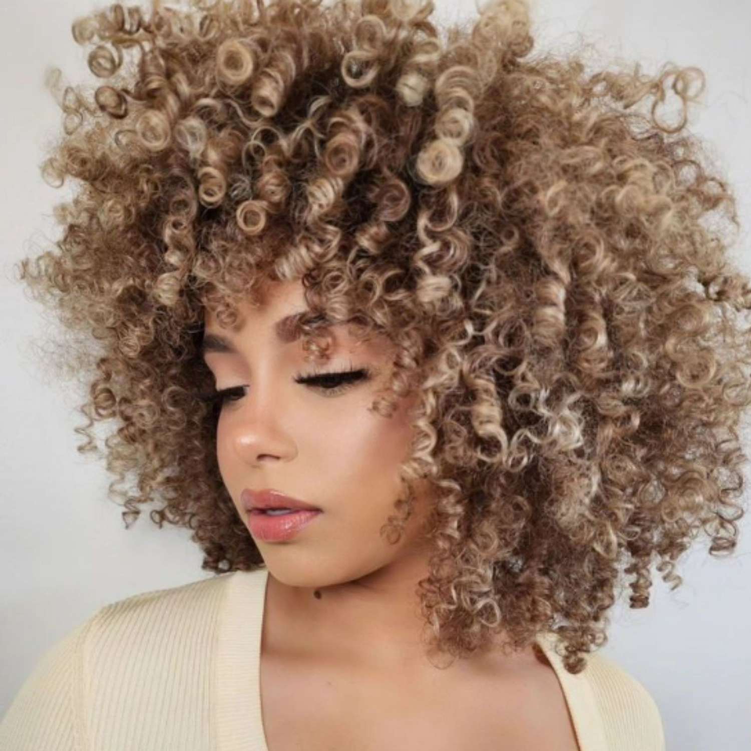 Tortoise-shell blonde balayage on a natural afro.