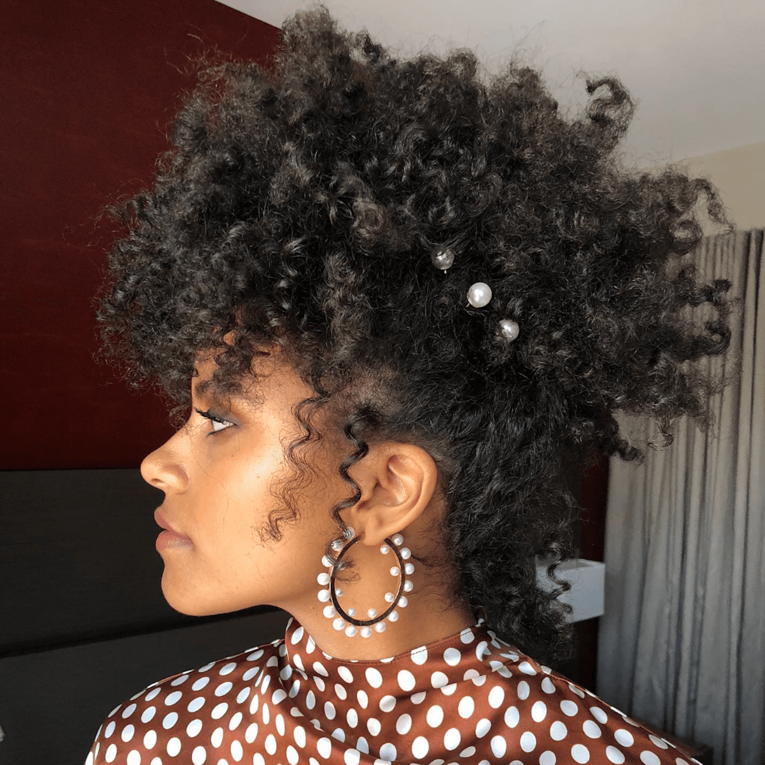 Zazie Beetz wears her natural texture shaped up and adorned with pearl bobby pins